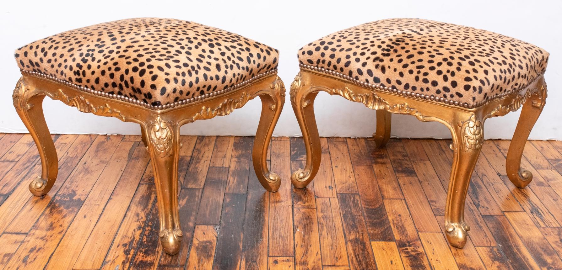 Pair of 1940s Italian Florentine wood benches. Benches were recently upholstered in faux leopard print leather. Gold leaf finish. 


