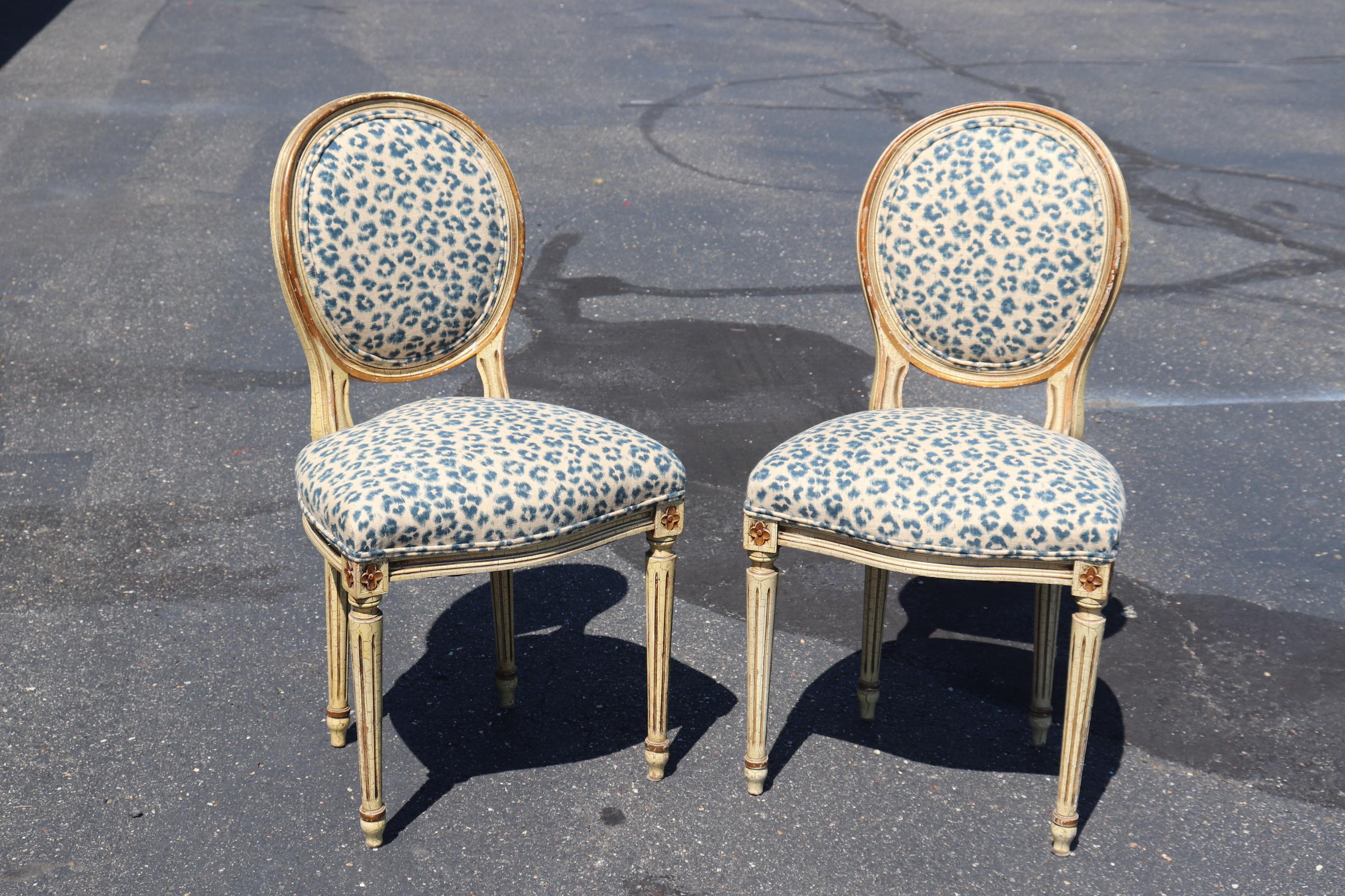 This is a gorgeous pair of distressed painted crackeled finish and chippy cameo back French chairs. The chairs are in a fantastic leopard upholtsery print (not real leopard folks) and have great chippy distressed finished paint. The gframes are