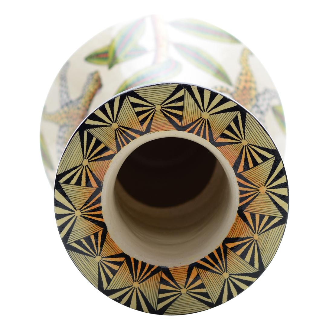 This Leopard Vase was hand sculpted by the renowned artisan Sfiso Mvelase and beautifully painted by Nozipho Ntshalintshali both from South Africa. This exquisite ceramic creation stands 12 inches high, measuring 7 inches in length and 7 inches in