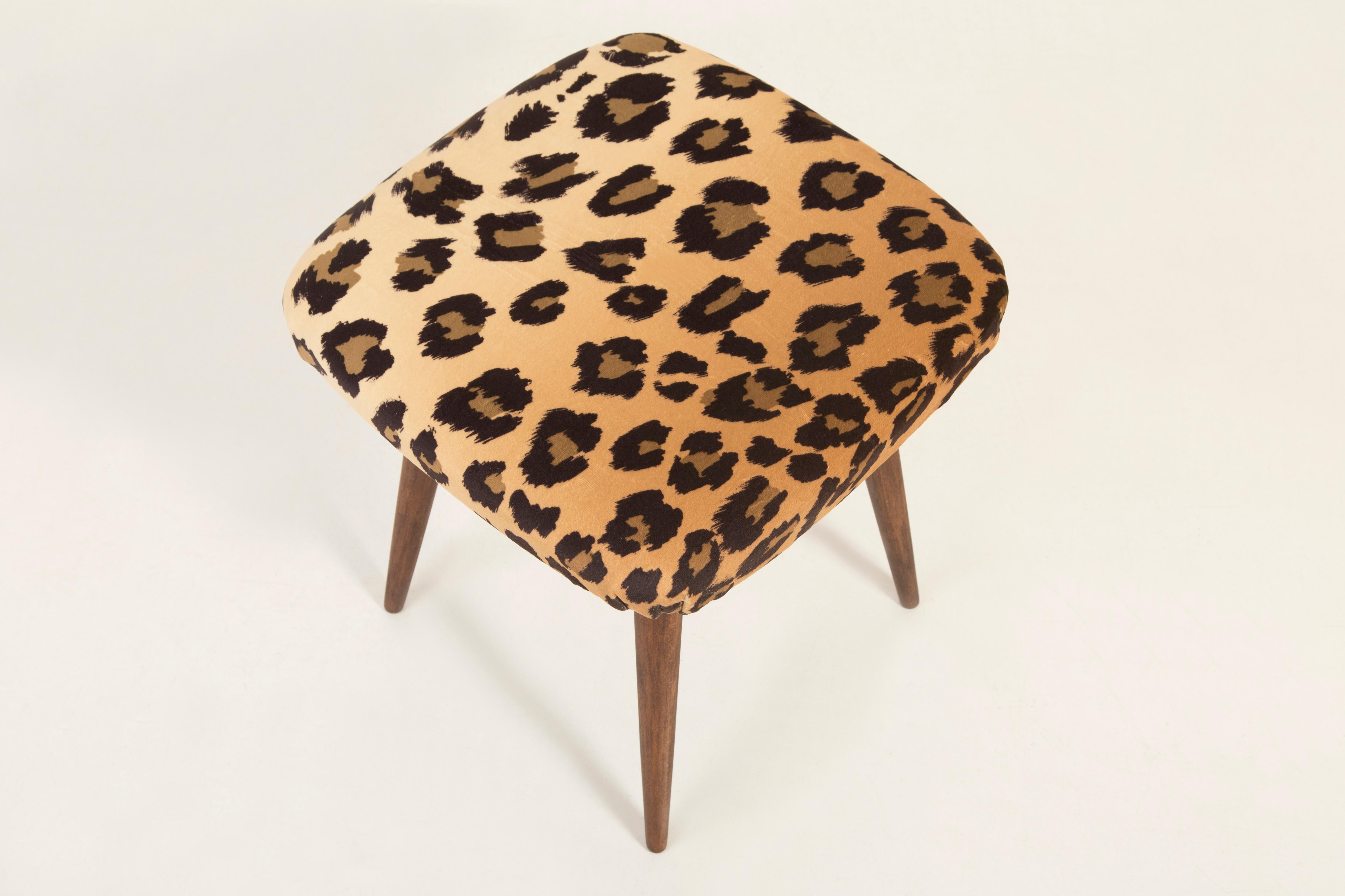 Stool from the turn of the 1960s and 1970s. Beautiful soft velvet leopard print upholstery. The stool consists of an upholstered part, a seat and wooden legs narrowing downwards, characteristic of the 1960s style.