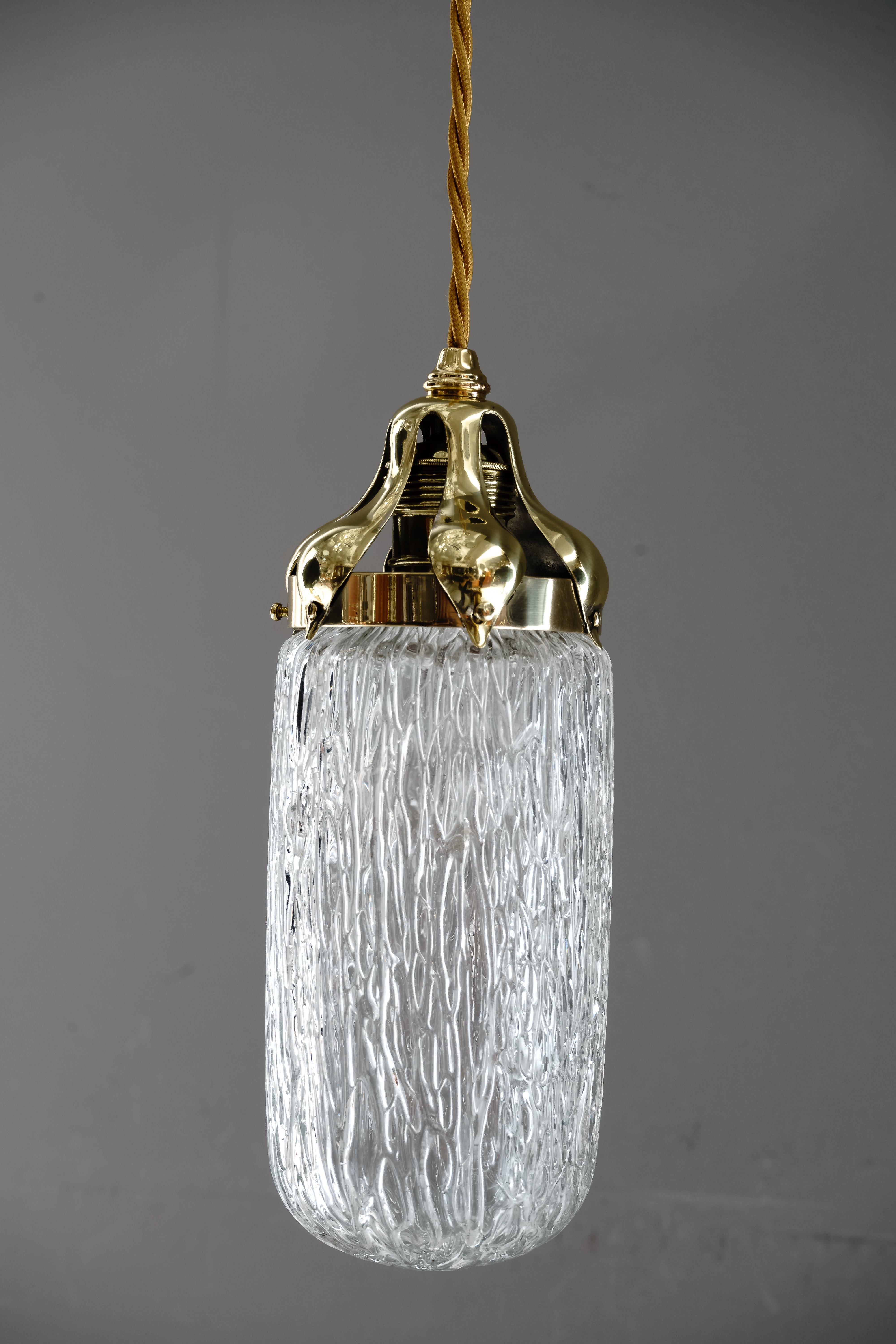 Leopold Bauer hanging lamp with Loetz Witwe “Blitzglas” shade, circa 1905
The brass parts are polished and stove enameled.
The glass shade was executed by Johann Loetz-Witwe Klostermuhle and is also in a very good condition.