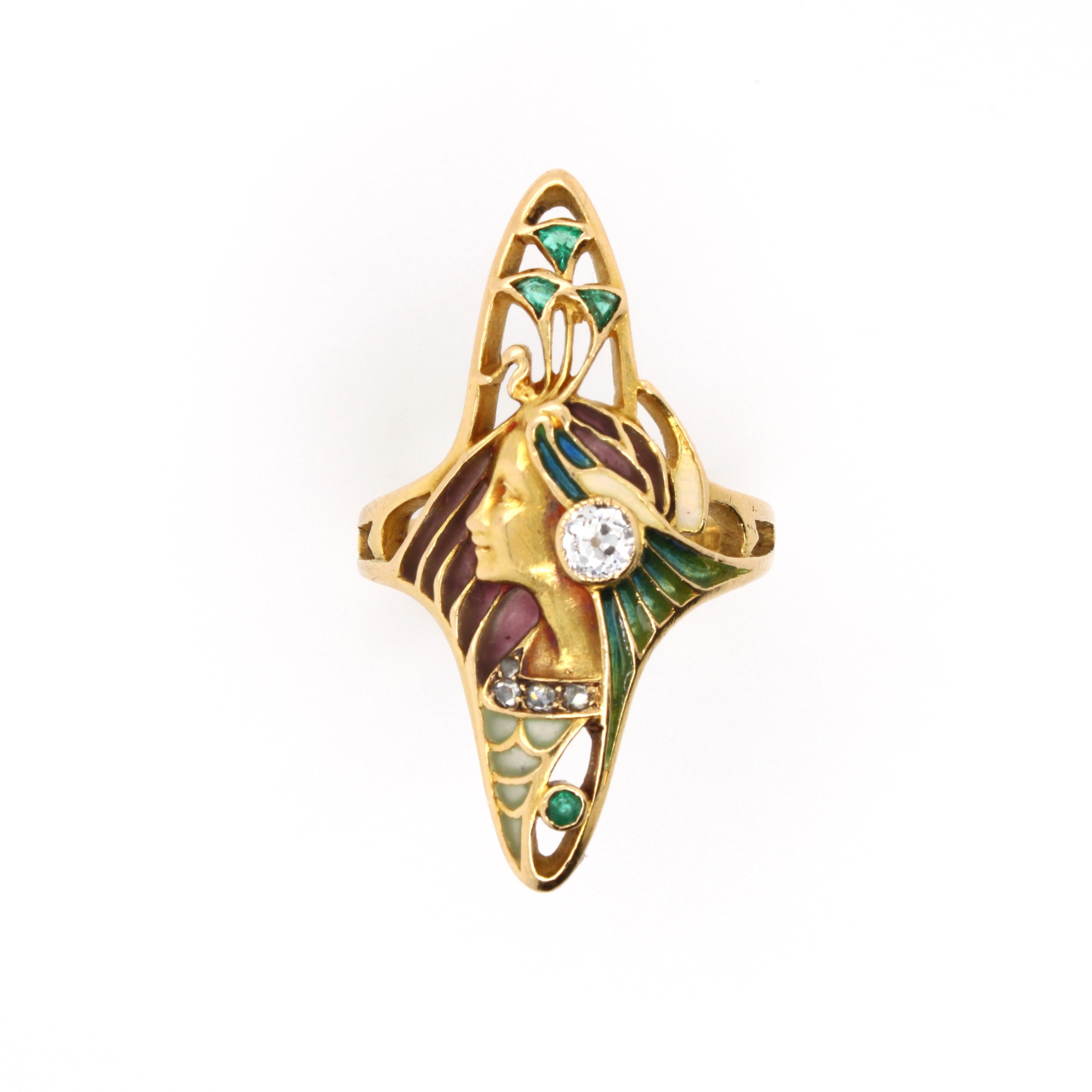 Rare Leopold Gautrait Art Nouveau Enamel and Gem-set Ring, ca. 1900

This exquisite Art Nouveau ring features the profile of a woman, wearing a peacock headdress, whose head feathers are depicted with emeralds. Furthermore the motif is swingfully