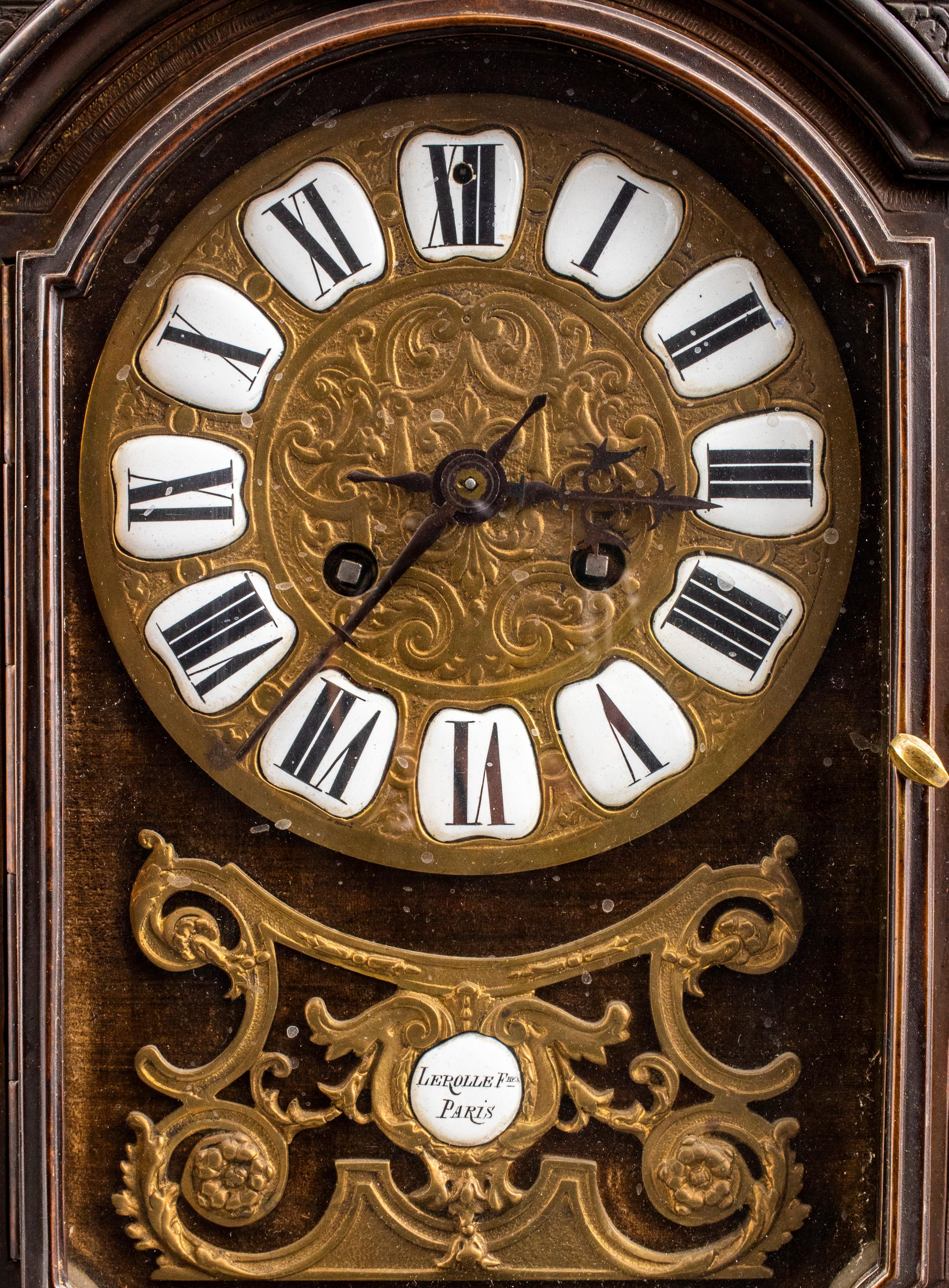 French Régence style bronze mantel clock by Lerolle Frères, Paris, second half 19th century, the case with Boulle style decoration having central masque over glass door, the dial with enamel Roman numeral chapters and plaque inscribed 'LEROLLE FRES