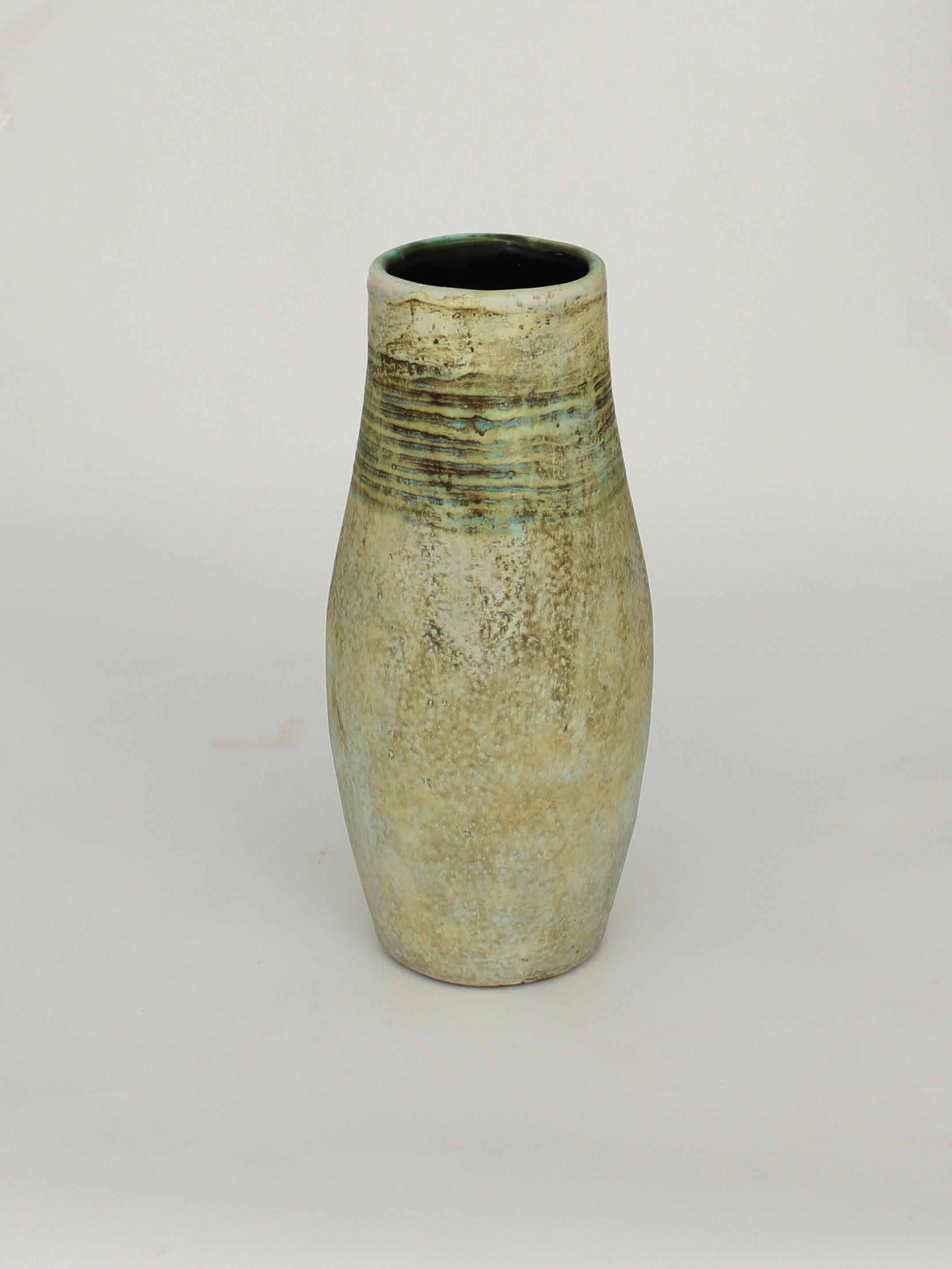 French ceramic artists Michelle and Jacques Serre 2 Potiers ceramic vase in the iconic color palette of mottled greens and blues.
This vase has wonderful banding of darker marking around the neck.
Signed 2 Potiers.
Similar vase shown on p 111 of the