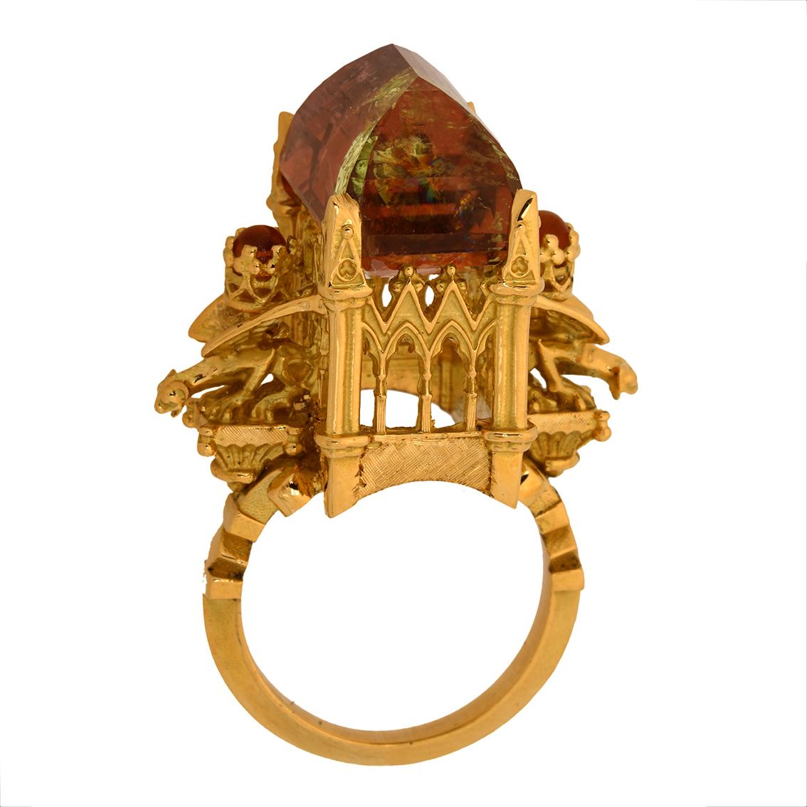 This captivating ring is a truly wondrous one of a kind piece.

Intricately handcrafted in 18kt yellow gold this glorious ring features a mesmerizing rich amber and green bi colour tourmaline resplendent atop a signature William Llewellyn Griffiths