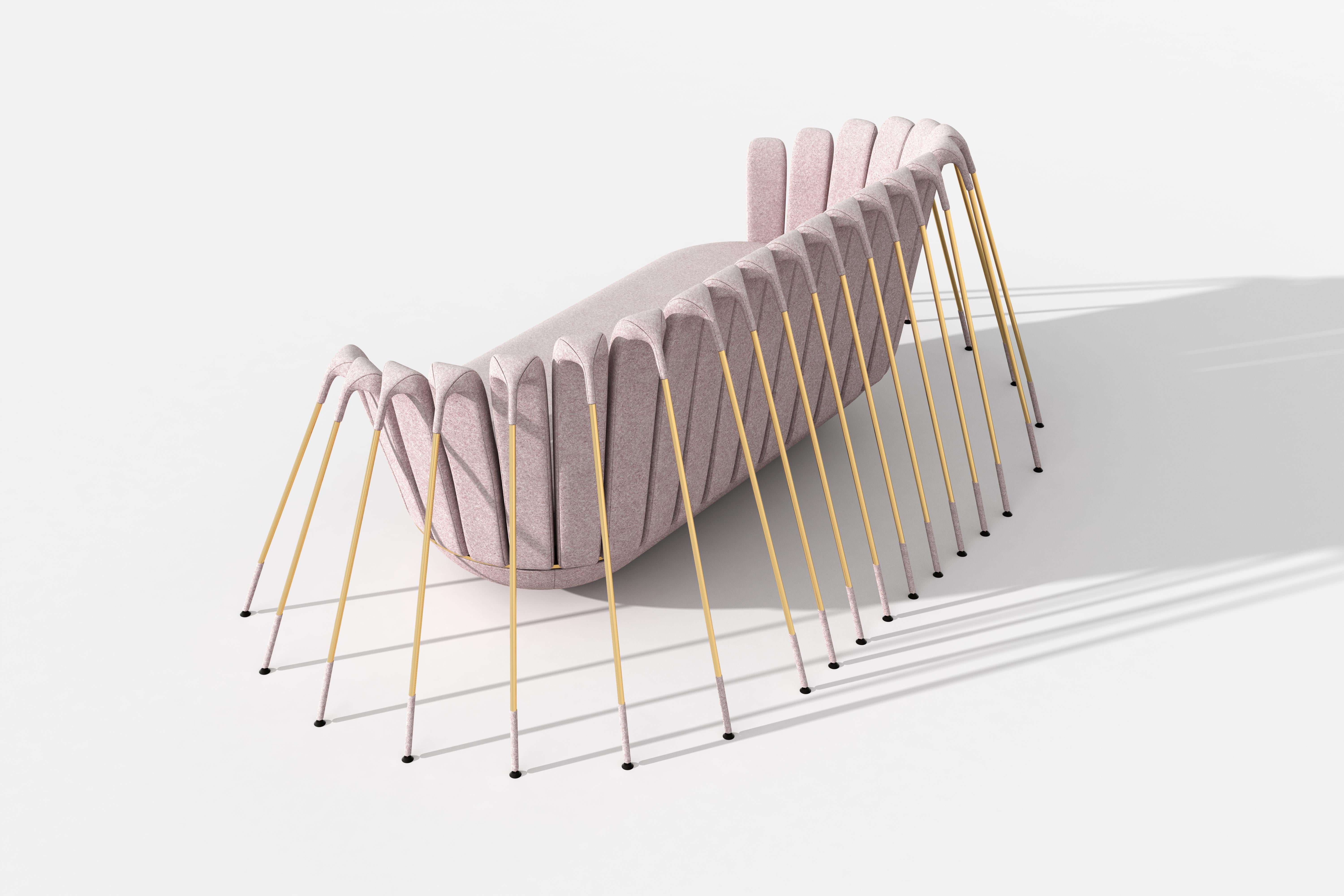 The Araigneé sofa has an upholstered seat in powder pink brushed cotton, placed on a rounded base and suspended by a multitude of gold metal legs.

While Marc Ange's most iconic creation Le Refuge proposed an island of safety and comfort, Les