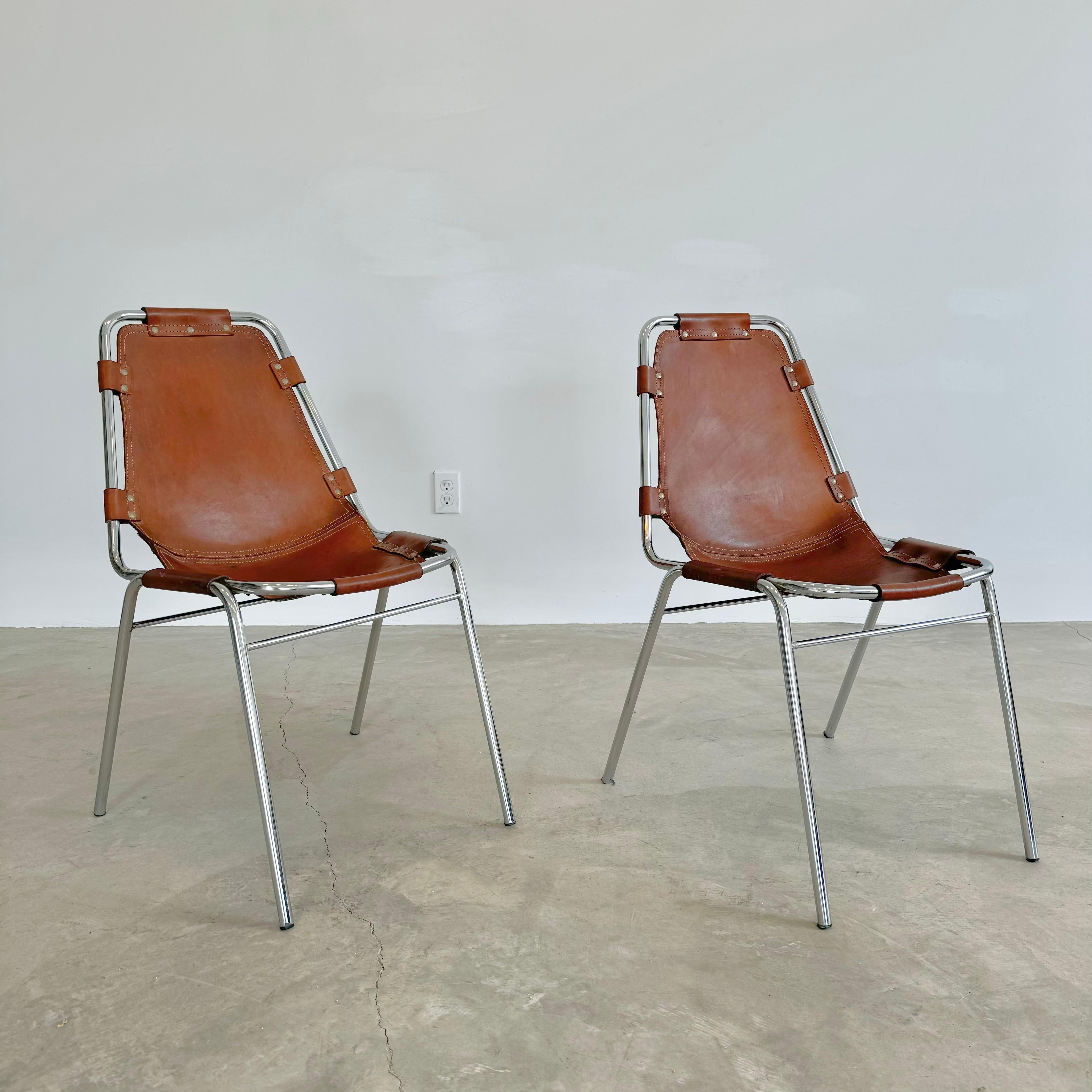 Fantastic chairs chosen by Charlotte Perriand for the Les Arcs ski resort. 1960s France. Tubular chrome frame with saddle leather held by rivets. Great condition to chrome. Fantastic condition and patina to leather. Completely original and