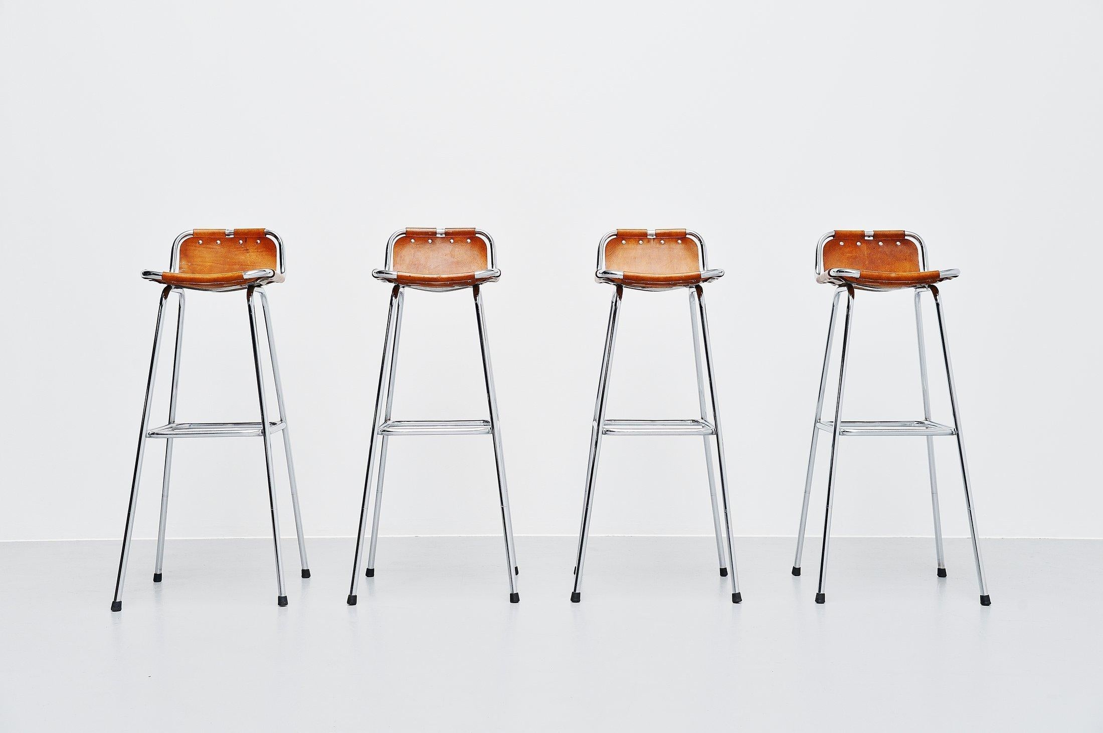 This is for a nice set of 4 high bar stools selected for Les Arcs, France, 1960. So this was the style of Charlotte Perriand. The stools have a chrome plated tubular metal frame and natural leather seats. These or for sure one of the nicest stools