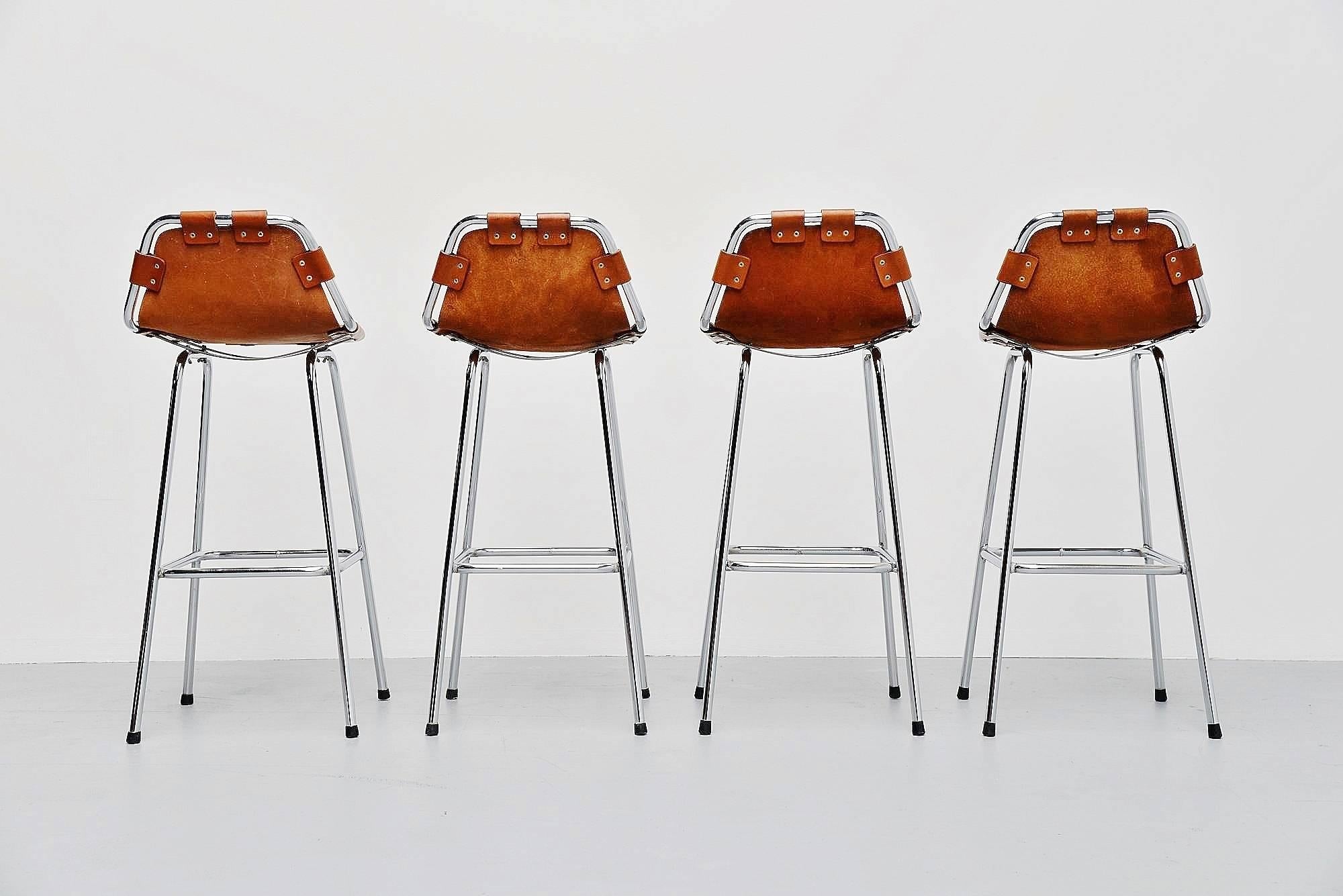 Stunning set of bar stools used by Charlotte Perriand for Les Arcs ski resort, France 1960. The stools have chrome-plated tubular metal frames and thick natural leather seats with amazing patina. These four stools are one of the best I had in years,