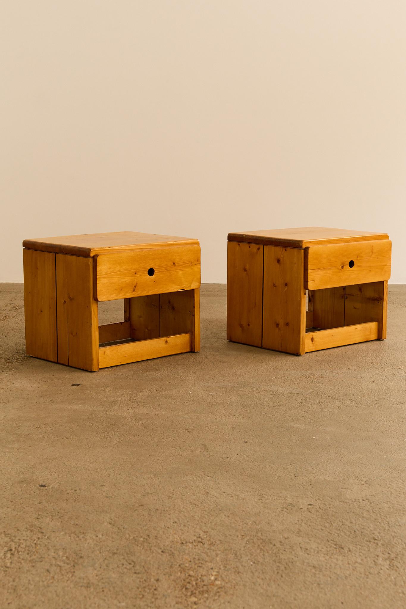 A pair of bedside tables with one drawer with circular handle, selected by Charlotte Perriand to furnish the Arcs 1800 apartments, a real estate project to which she devoted nearly 20 years of her life. Price is for the pair.