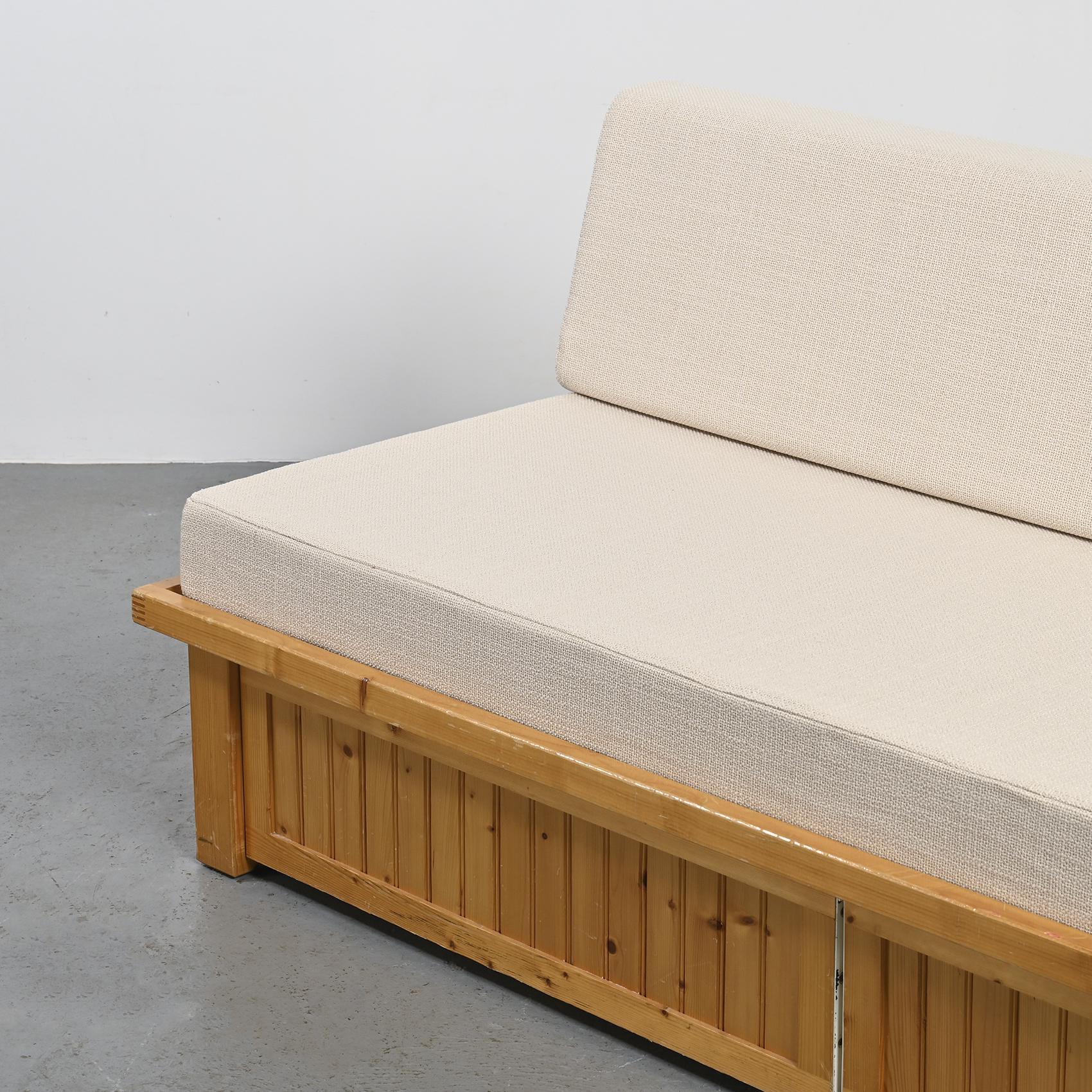 Imagined by Charlotte Perriand, this sofa bed was once part of the furnishings in the apartments of the Residence Nova in Les Arcs.

The structure of this piece is crafted with pine slats and conceals two rolling drawers accessible through a flap.