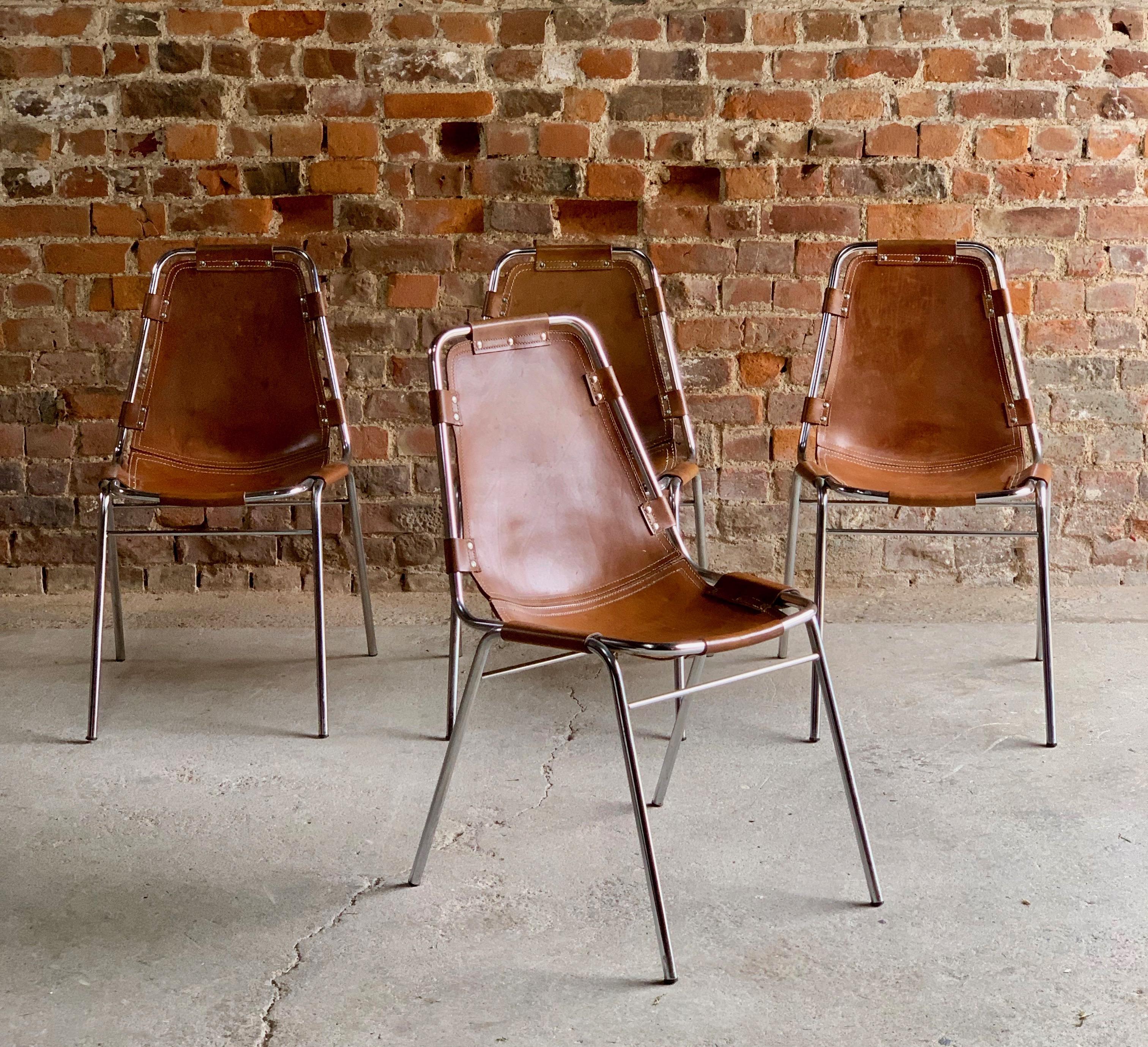 Charlotte Perriand dining chairs leather four Les Arcs 1970s original.

Fabulous set of four tan leather 'Les Arcs' dining chairs designed by Charlotte Perriand for Cassina in the 1960s for the Les Arcs ski resort, each chair consists of a chrome