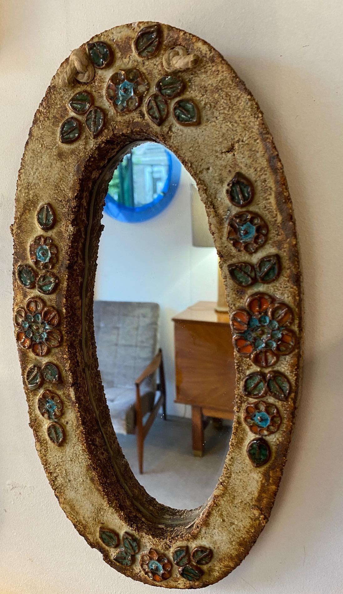 Ceramic mirror, France, Vallauris, 1960s.
Attributed to Les Argonautes (Frédérique Bourguet and Isabelle Ferlay), French workshop created in Vallauris, south of France, in 1953 and active until the death of Federique Bourguet in 1997.