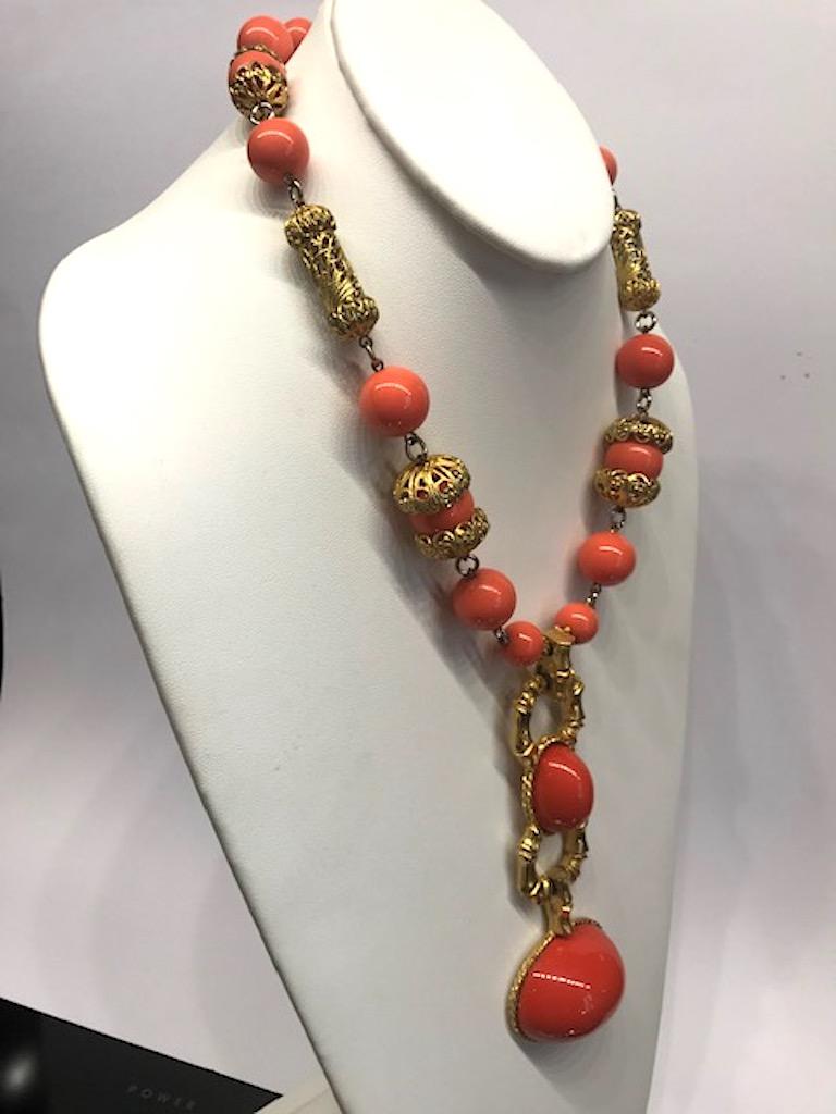 A lovely faux coral lucite bead and cabochon necklace by Les Bernard circa 1980. Bottom large cabochon is 1.63 inches wide, 1.25 inches high and .75 inches high. It is suspended from another smaller 1 inch by .75 vertical cabochon mounted in a