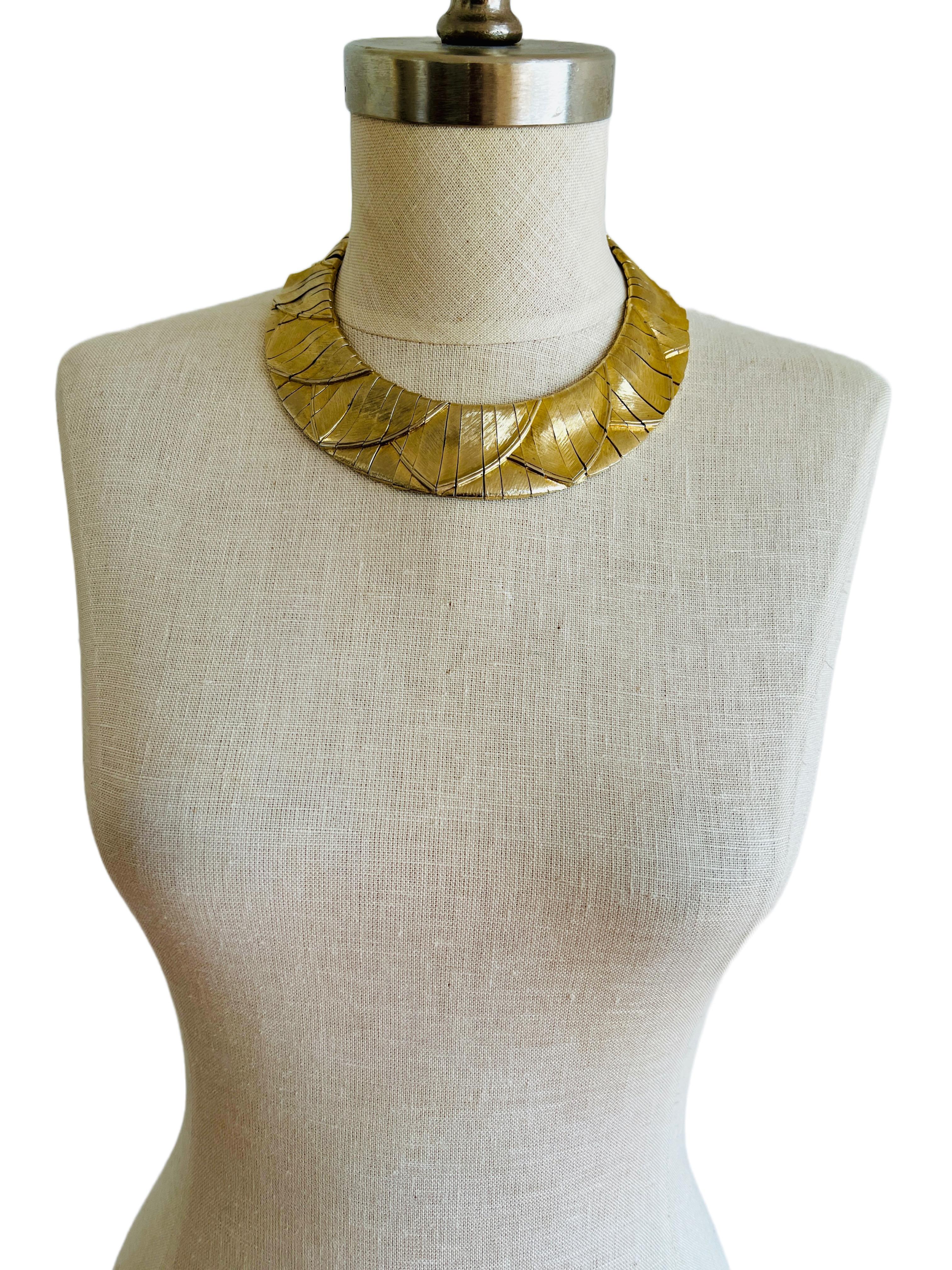 Elegant Les Bernard collar choker necklace, featuring an Egyptian Revival motif in soft pale gold with a brushed finish. Comprised of 68 interconnected segments through an internal chain, this sophisticated accessory is perfect for achieving your