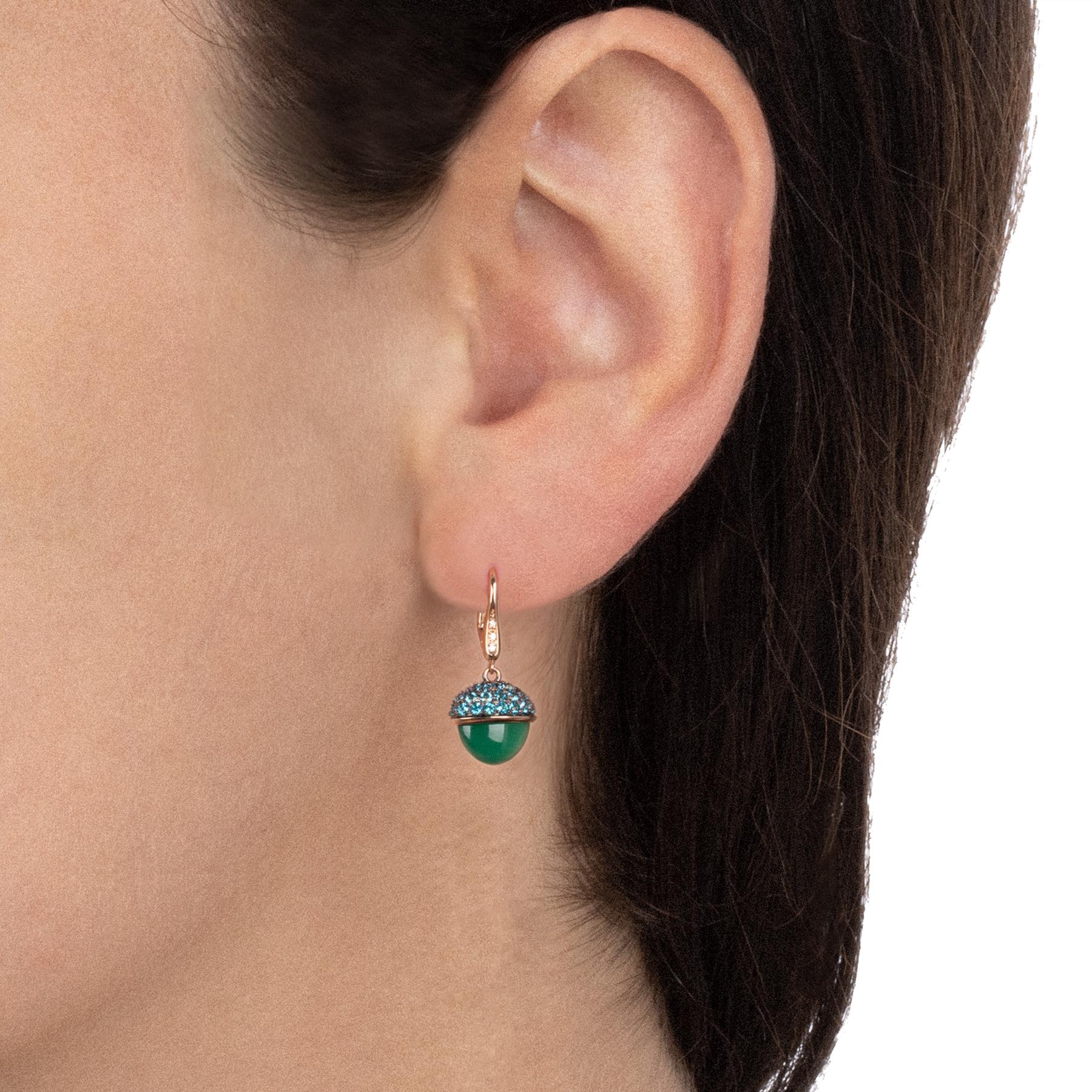 Elegant gold earrings characterized by pendants with stone wrapped in a pavè of blue paraiba that give a touch of freshness to the jewel. The stone seems to blossom like a spring gem. Three diamonds enrich the hook. 

18 kt rose gold earrings with