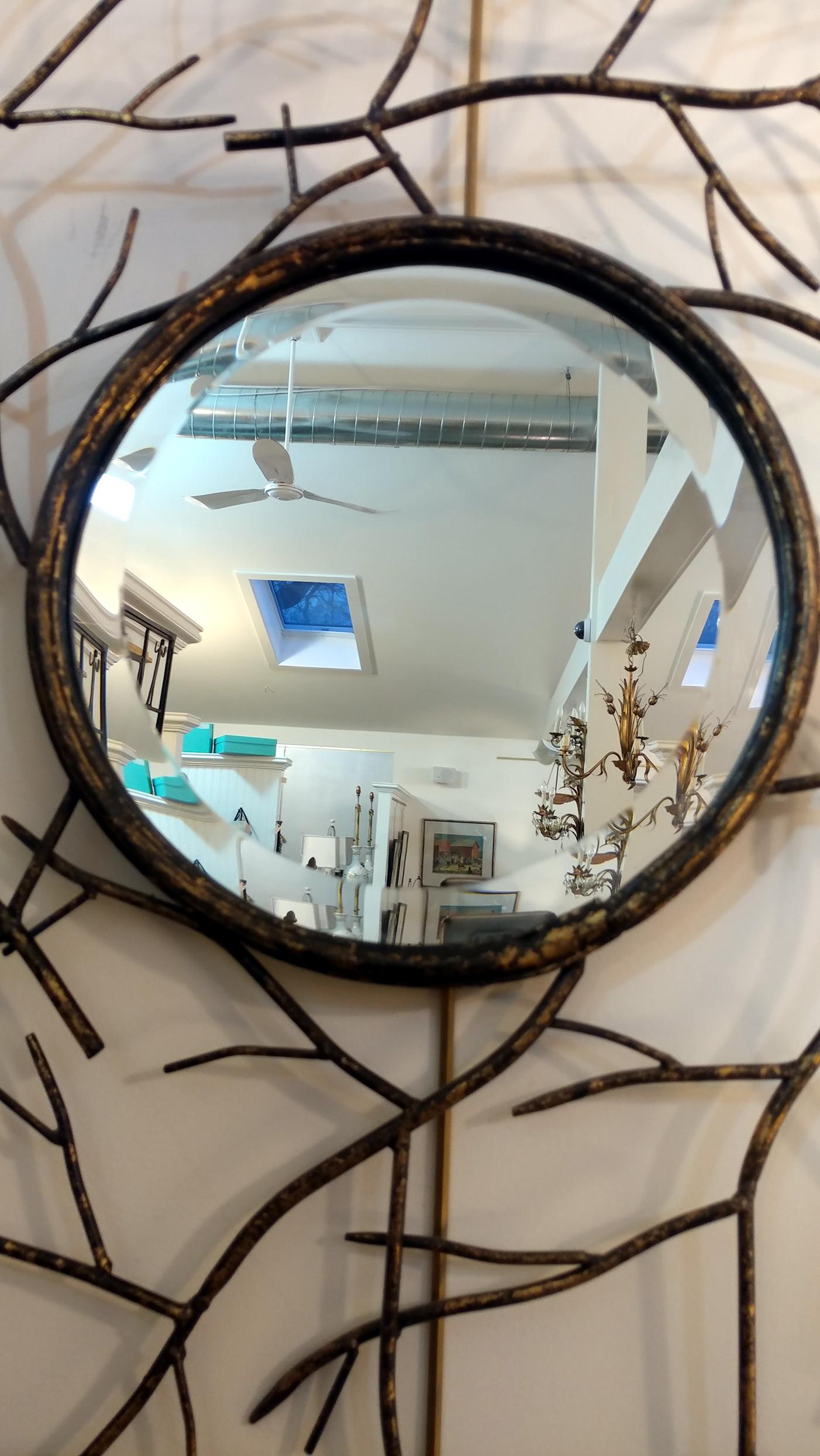 Striking les branches convex mirror, lovely patinated gilt on wrought iron twigs frame. Beveled edge on mirror, circa 1970s, in overall good vintage condition, there's a 2 inch hairline on mirror surface, though it is not too noticeable, we can also