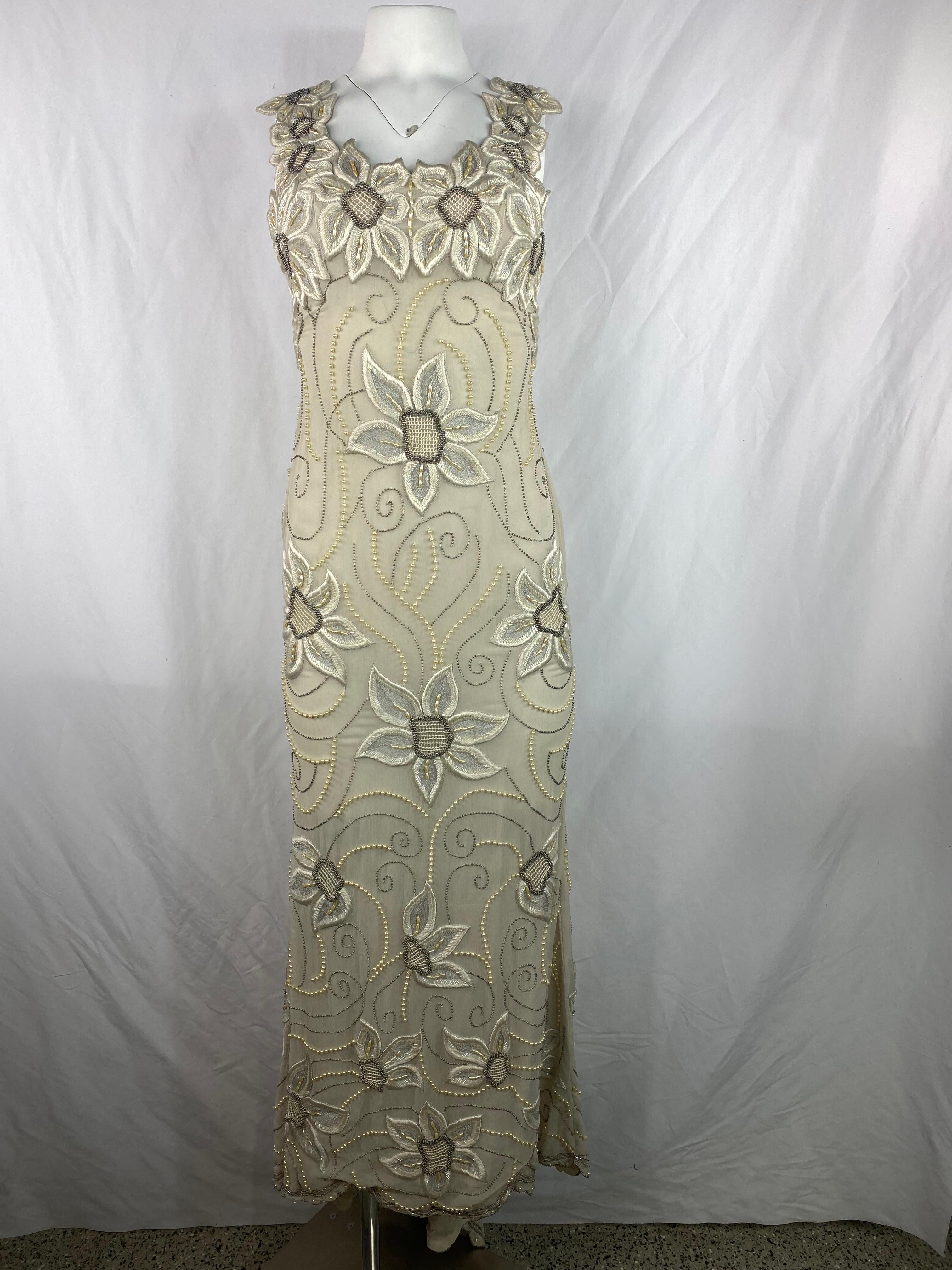 Product details:

The dress is made out of 100% silk, beads and pearls. It features cream, beige, brown and white colors, floral embroidered motif. The front measures 55 inches long and the back is 64 inches long.