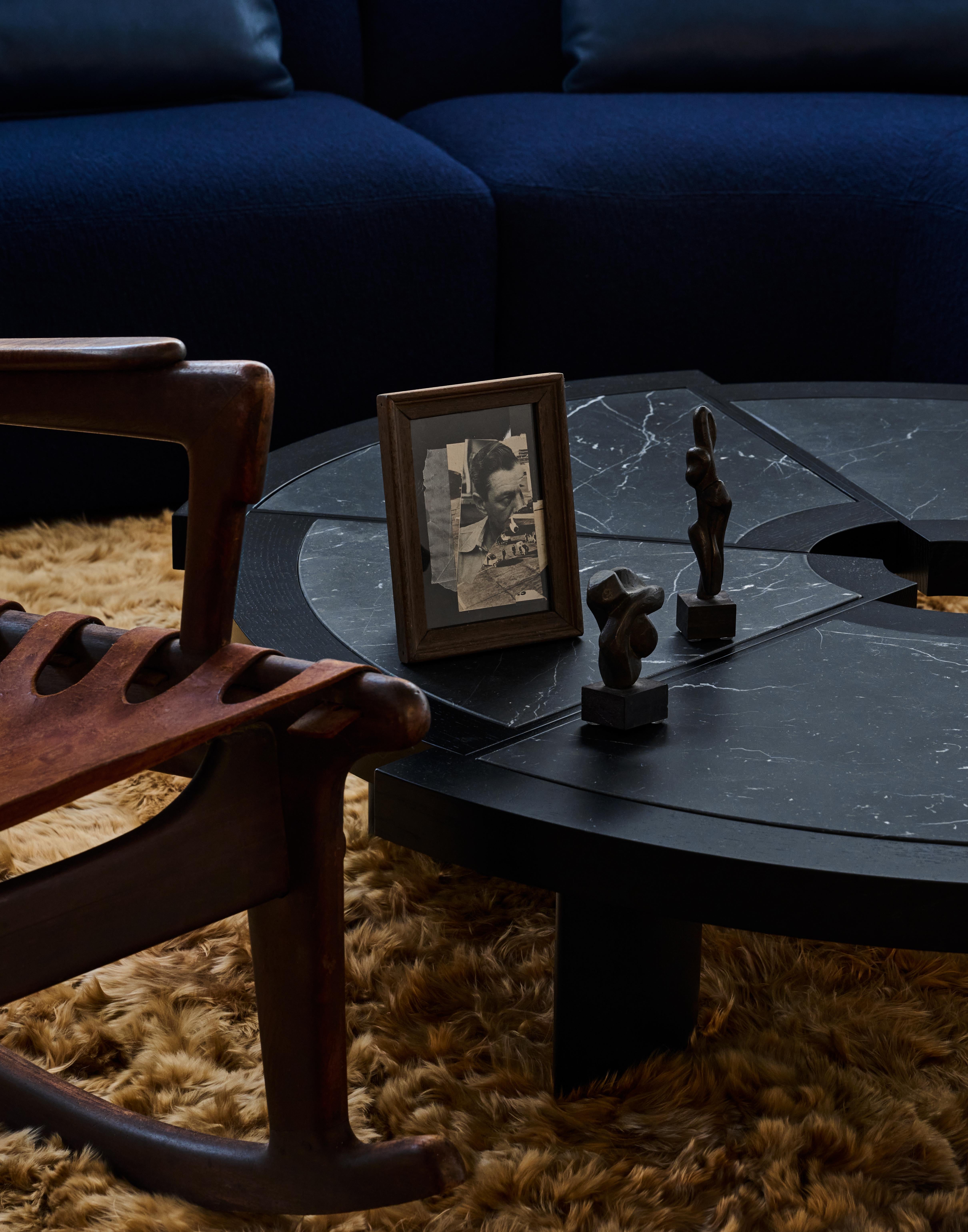 This compelling sculptural duo exemplifies the enduring power of reductive form and material honesty that defined mid-century modernism. Carved from richly veined dark stone and finished to a lustrous patina, each piece distills the essence of the