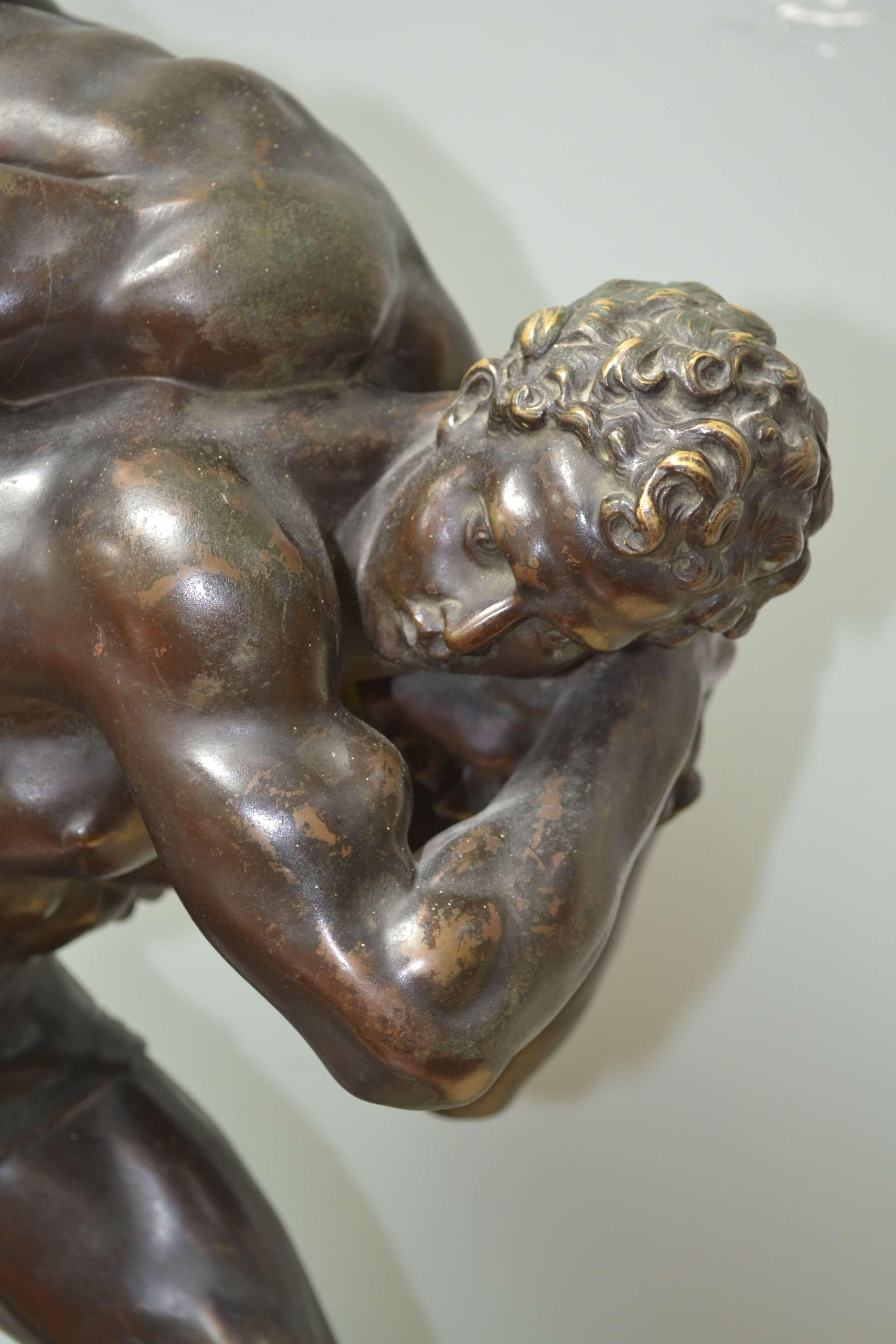 A rare bronze titled Les Lutteurs (The Wrestlers) by Francois Marius Laugier depicting two classically proportioned male figures at the peak of youth and strength, in the pivotal moment in wrestling, after the initial lift and before the fall. The