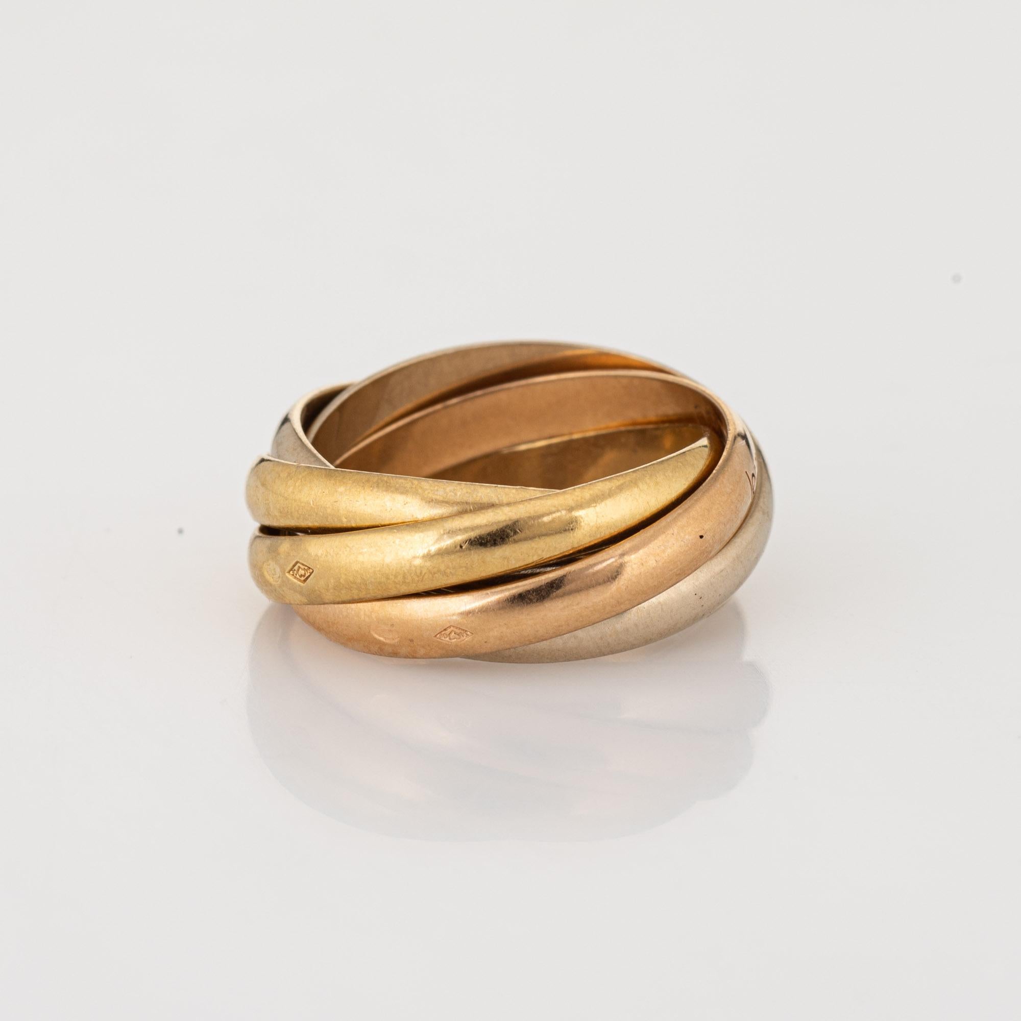 Vintage les Must de Cartier 5 band Trinity ring crafted in 18k yellow, white & rose gold (circa 1980s).  

The Cartier ring features 5 bands of 18k rose, yellow & white gold. Each band measures 3mm wide. The ring is great worn alone or layered with