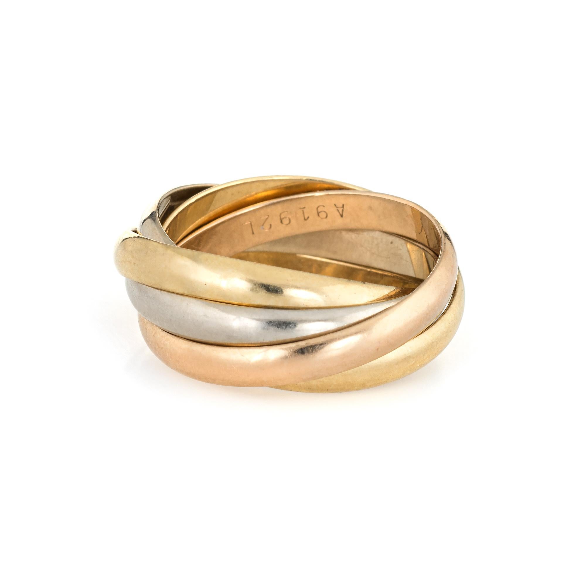 Pre owned les must de Cartier Trinity 5 band ring crafted in 18 karat yellow, rose and white gold.  

The ring features five bands with 2 yellow gold, 2 white and 1 rose gold. Each of the bands measure 3mm.

The ring is in very good condition. We