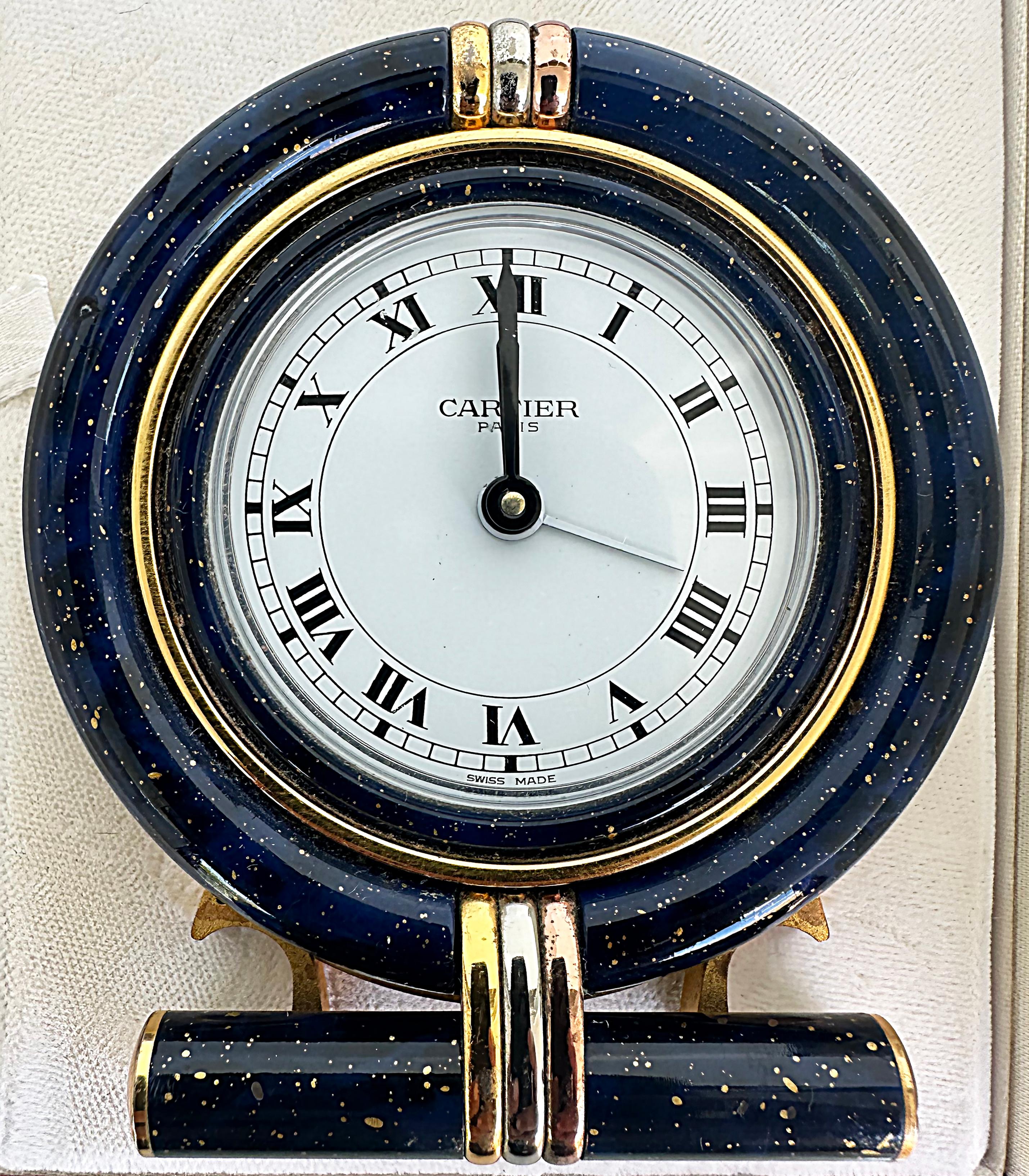 Les Must de Cartier Paris Enamel Gold Plated Travel Clock with Original Case


Offered for sale is a Les Must de Cartier Paris enamel gold plated travel clock with the original Cartier case or box. The clock is enameled with a lapis-look finish