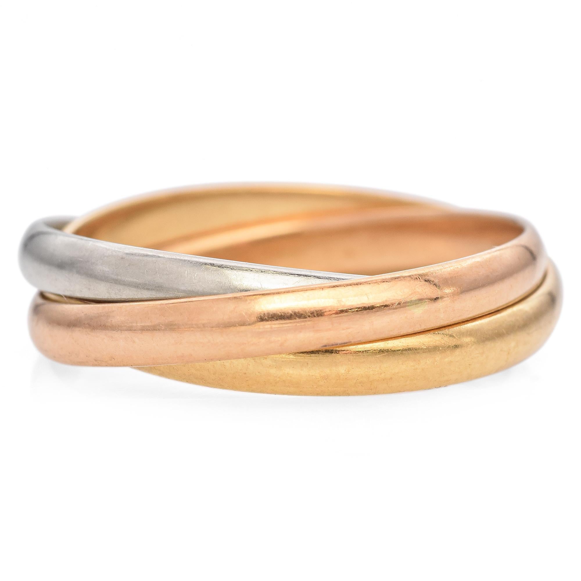 This exquisite piece by Cartier features signature three interlocking bands crafted from 18k gold.
Each band showcases a distinct hue: yellow, white, and rose gold, creating a harmonious blend of colors with elegant simplicity.

Weight: 4.7