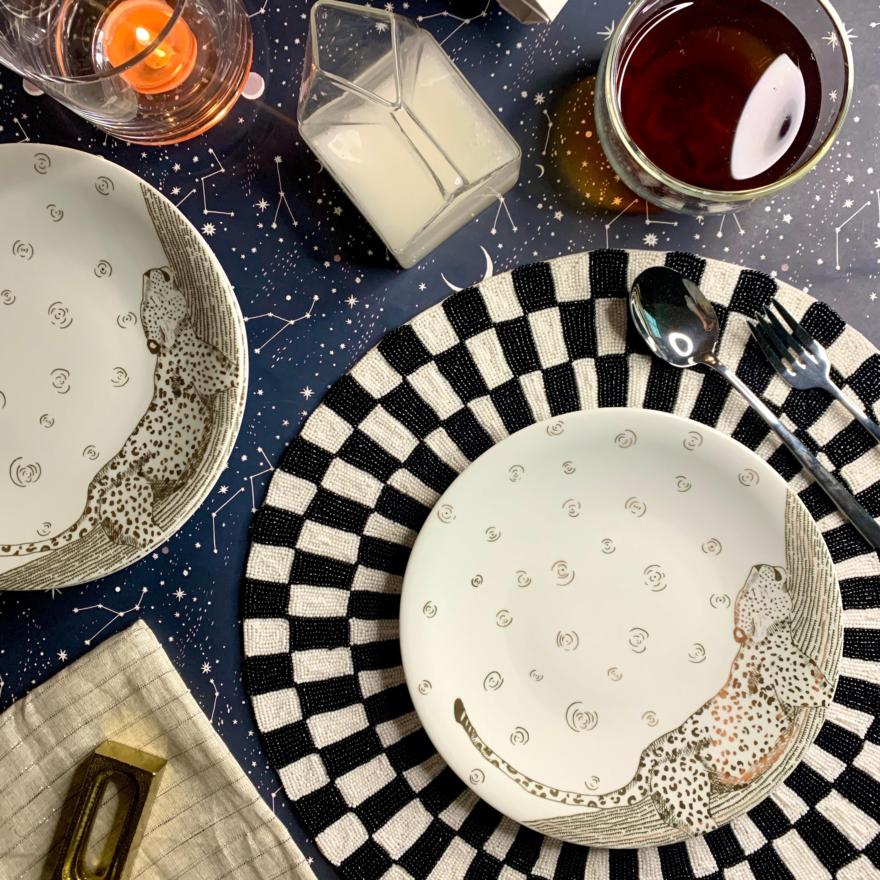 The Les Navas Dessert Set features a hand-painted guilded leopard in 12k Gold under the night sky. The activities of this great animal are showcased in the motif of this set. Playful, chic and dynamic- this dinner set will shine on your dinner