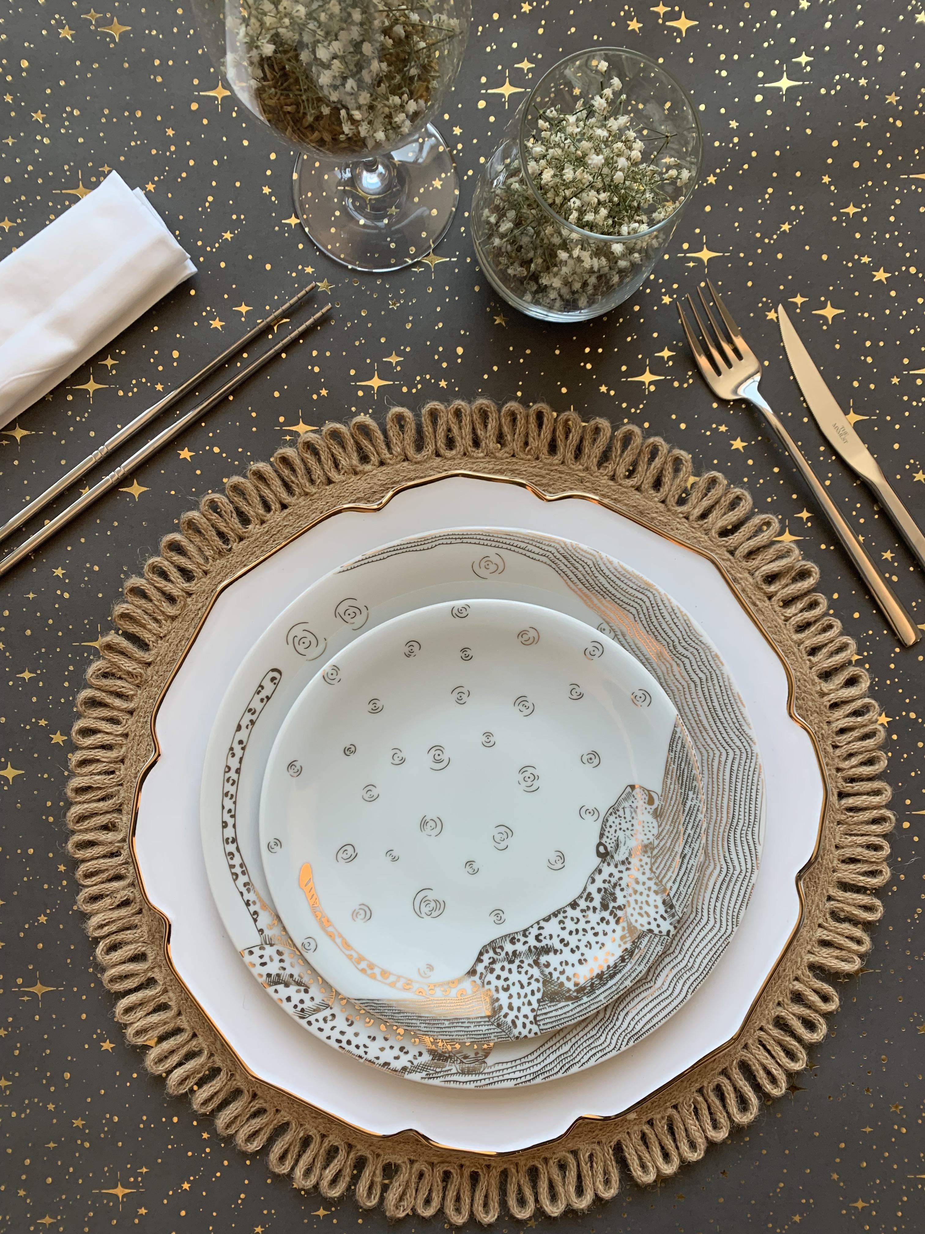 The Les Navas dinner set features a hand-painted guilded leopard in 12k Gold under the night sky. The activities of this great animal are showcased in the motif of this set. Playful, chic and dynamic- this dinner set will shine on your dinner table.