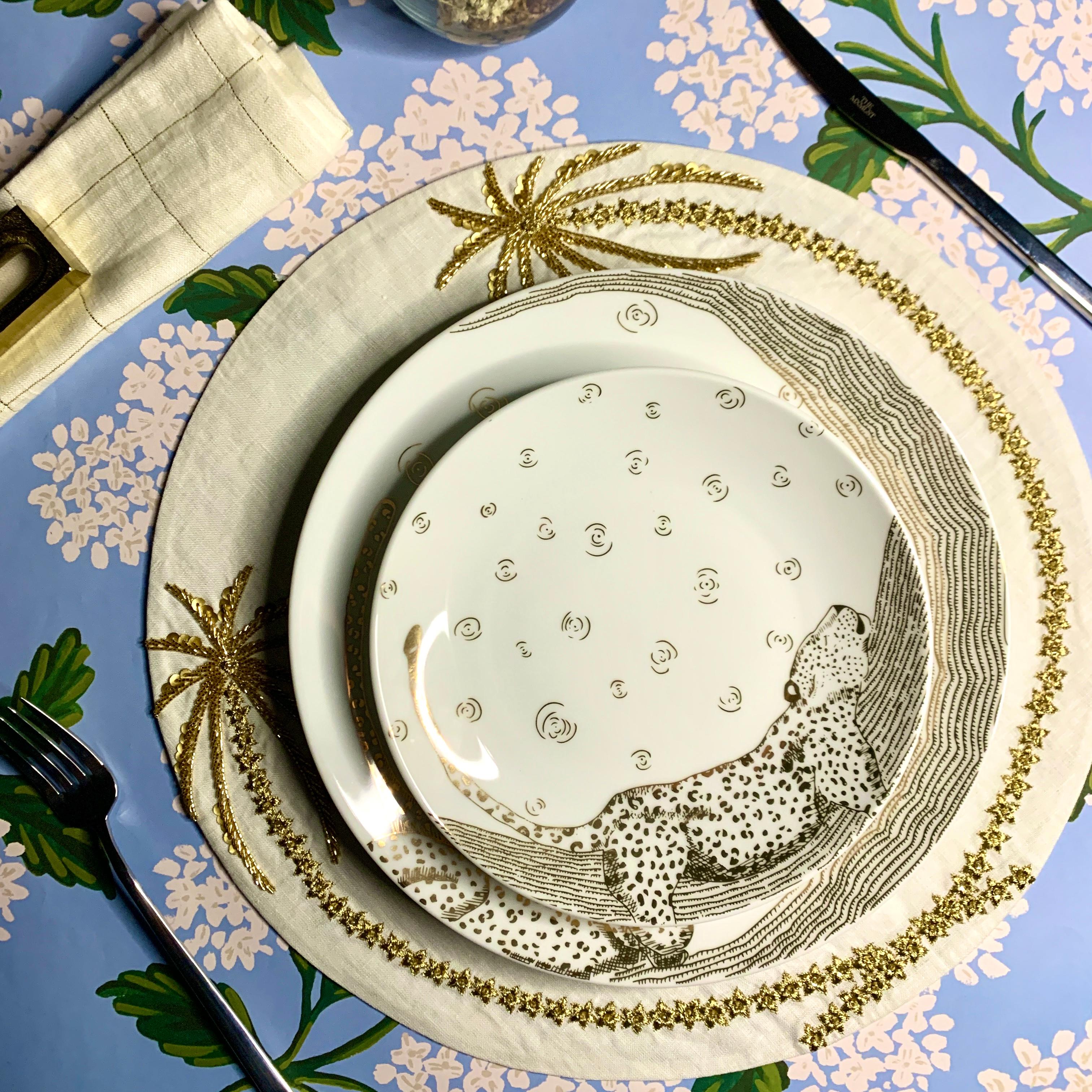 The Les Navas dinner set features a hand-painted guilded leopard in 12k Gold under the night sky. The activities of this great animal are showcased in the motif of this set. Playful, chic and dynamic- this dinner set will shine on your dinner table.