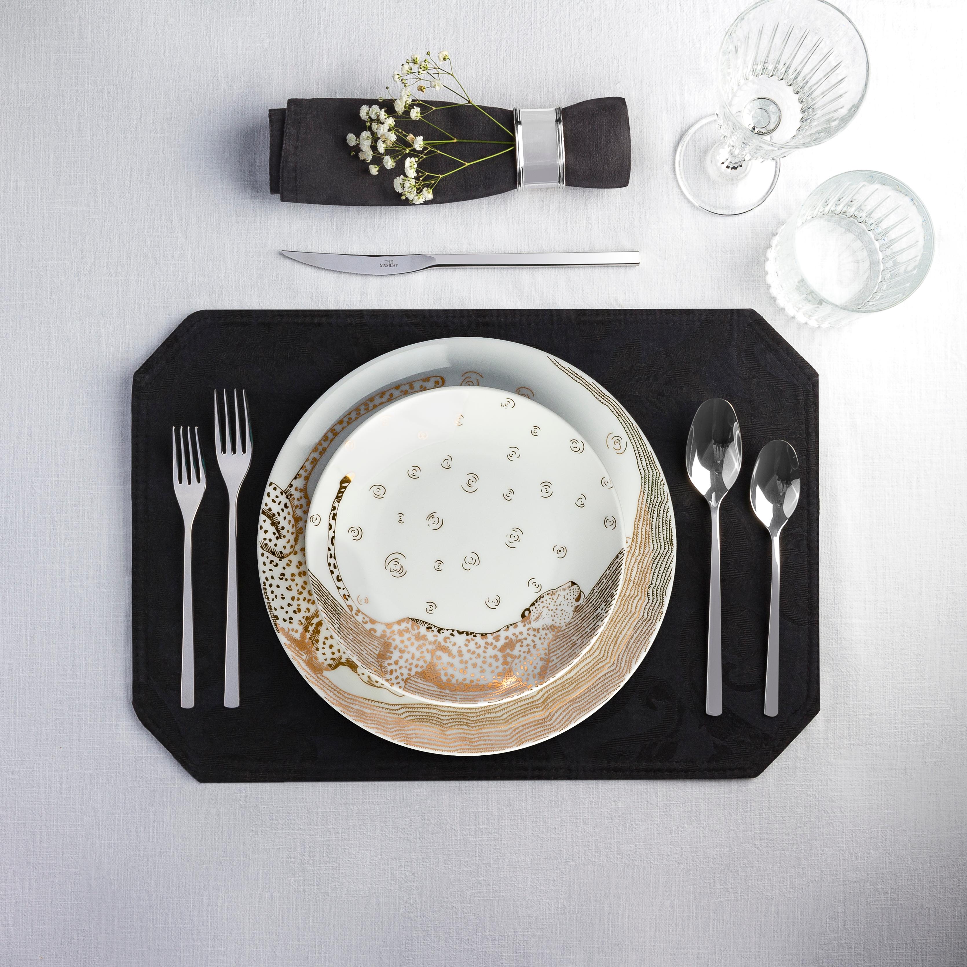 The Les Navas dinner set features a hand-painted guilded leopard in 12k Gold under the night sky. The activities of this great animal are showcased in the motif of this set. Playful, chic and dynamic- this dinner set will shine on your dinner table.