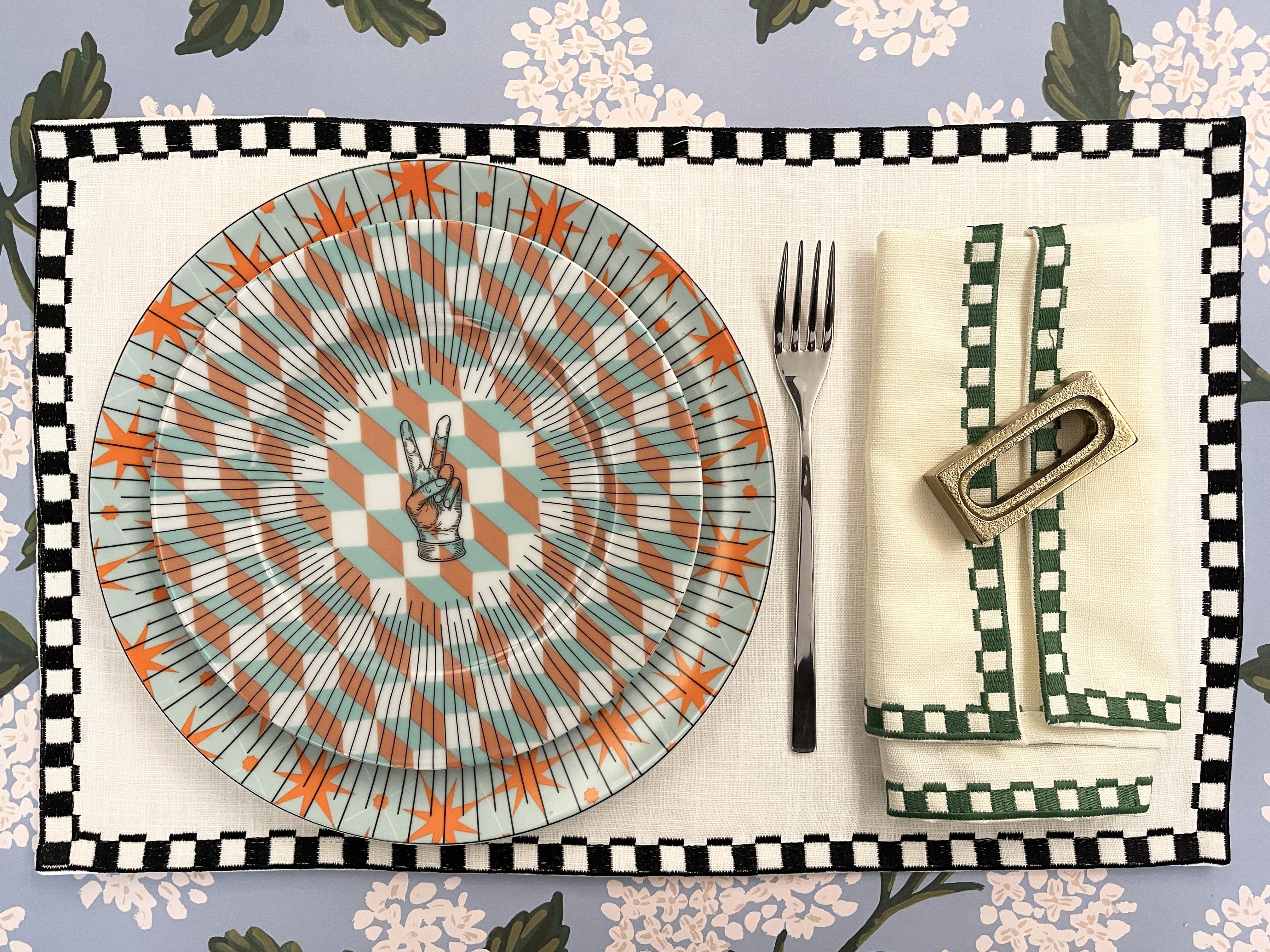 The Les Noelles placemat is a classic placemat that will elevate your dining experience. Made in 100% Linen, the naokin features embroidered geomterical patterns that online the edge and gives the napkin a polished look. This is a set of 4
