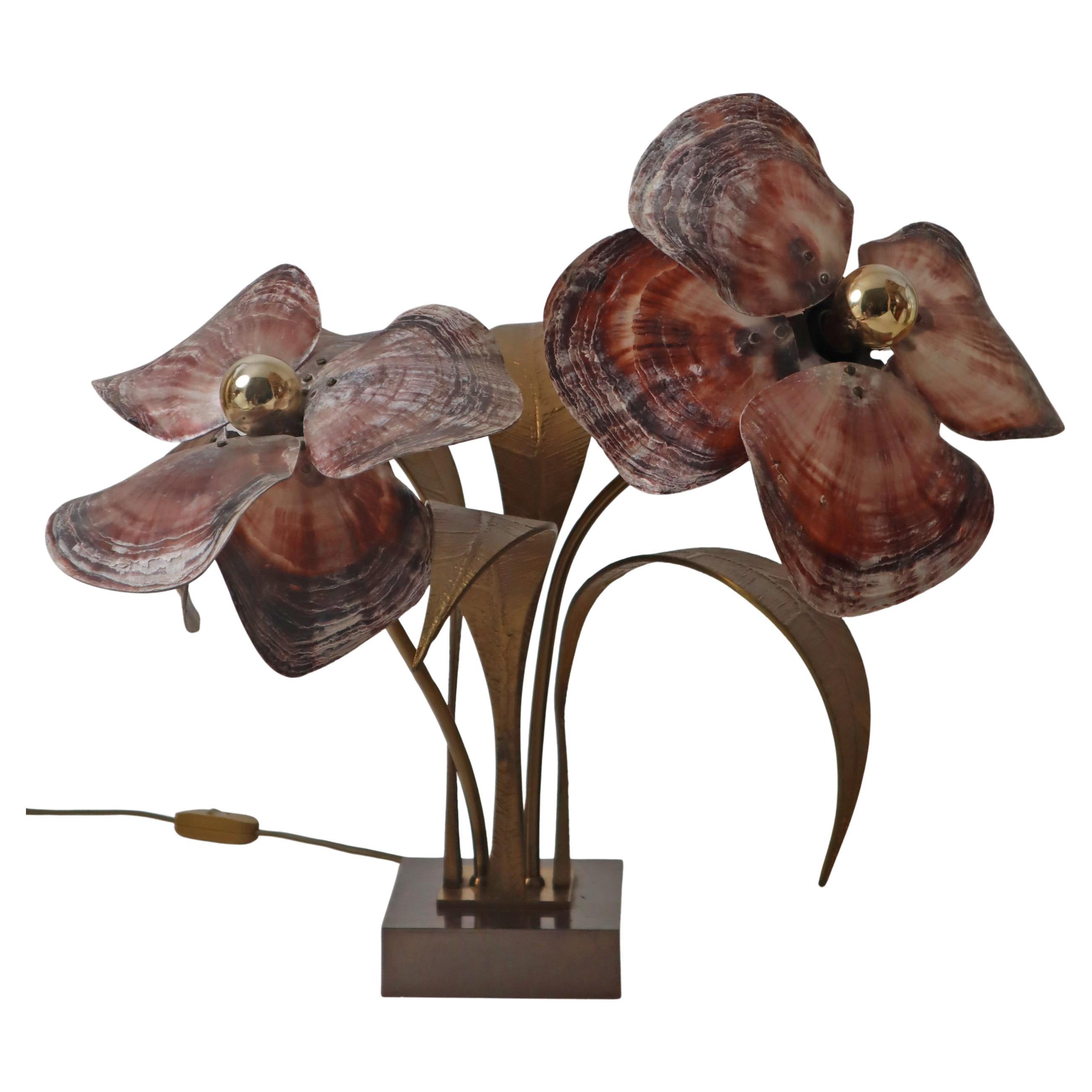 This Willy Daro flower table lamp is of high quality. It is a rectangular brass base with four moulded bronze leaves,brass parts and screws, ten pink oyster shell petals which form the lampshades. This is a hand made lamp and any type of light lamp