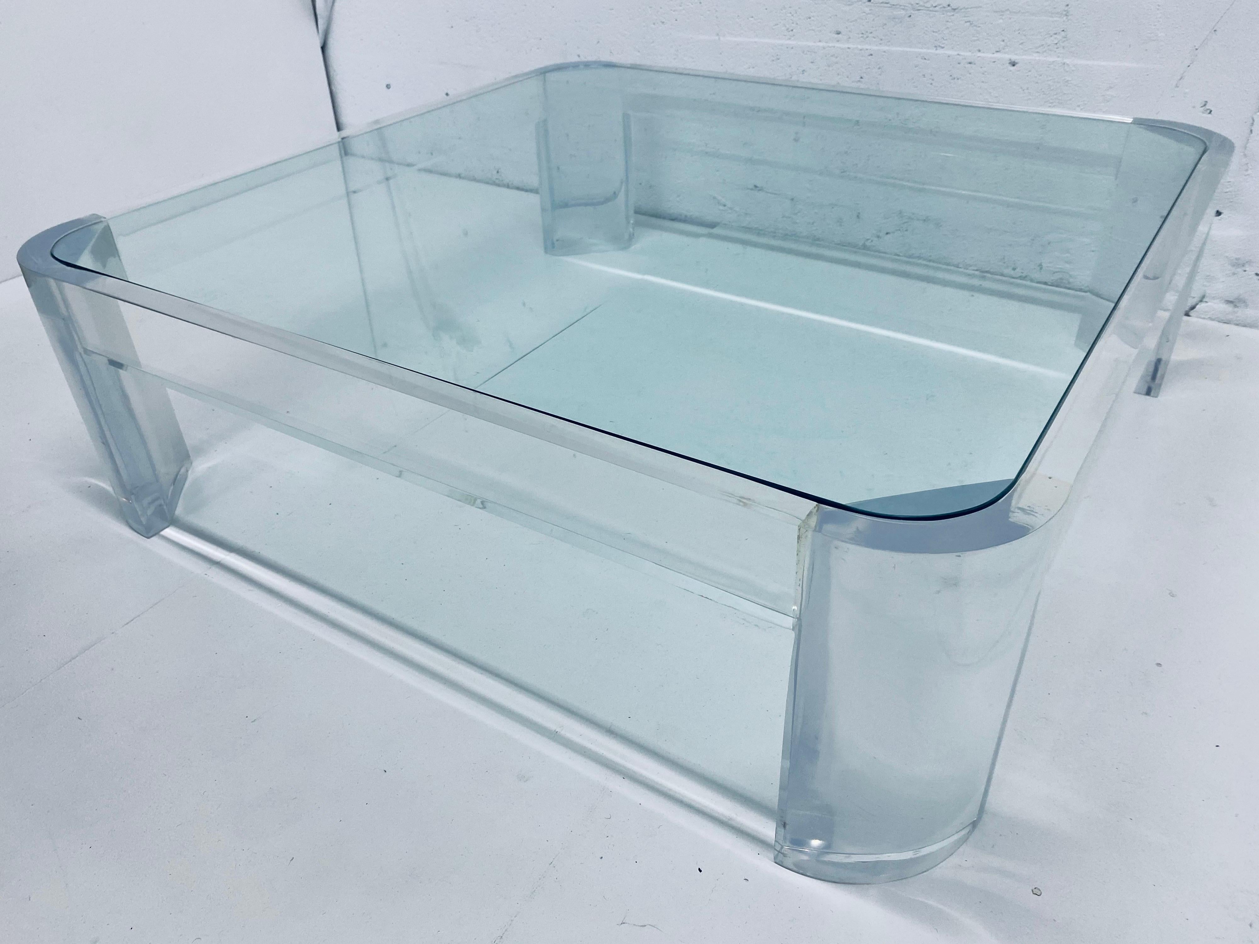 Thick Lucite frame with inset clear glass top coffee table from the 1970s by Les Prismatiques. Lucite frame is 1-1/2