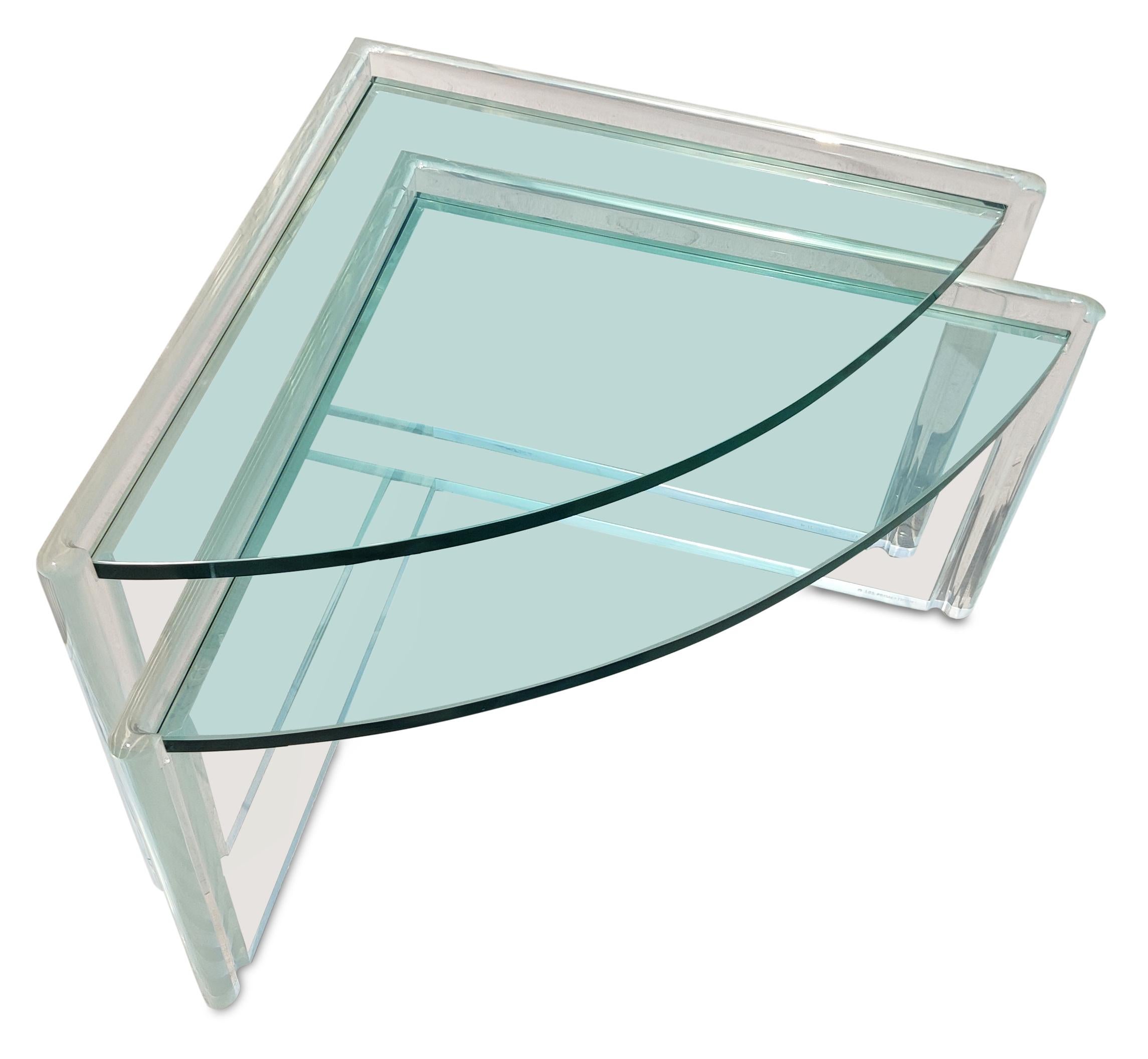 These stunning lucite and glass tables were made in the 1990s by manufacturer Les Prismatiques. Shaped like rounded triangles, each table is made of 1.5 inch thick lucite and 3/4 inch thick glass. Very dense and solid construction make these very