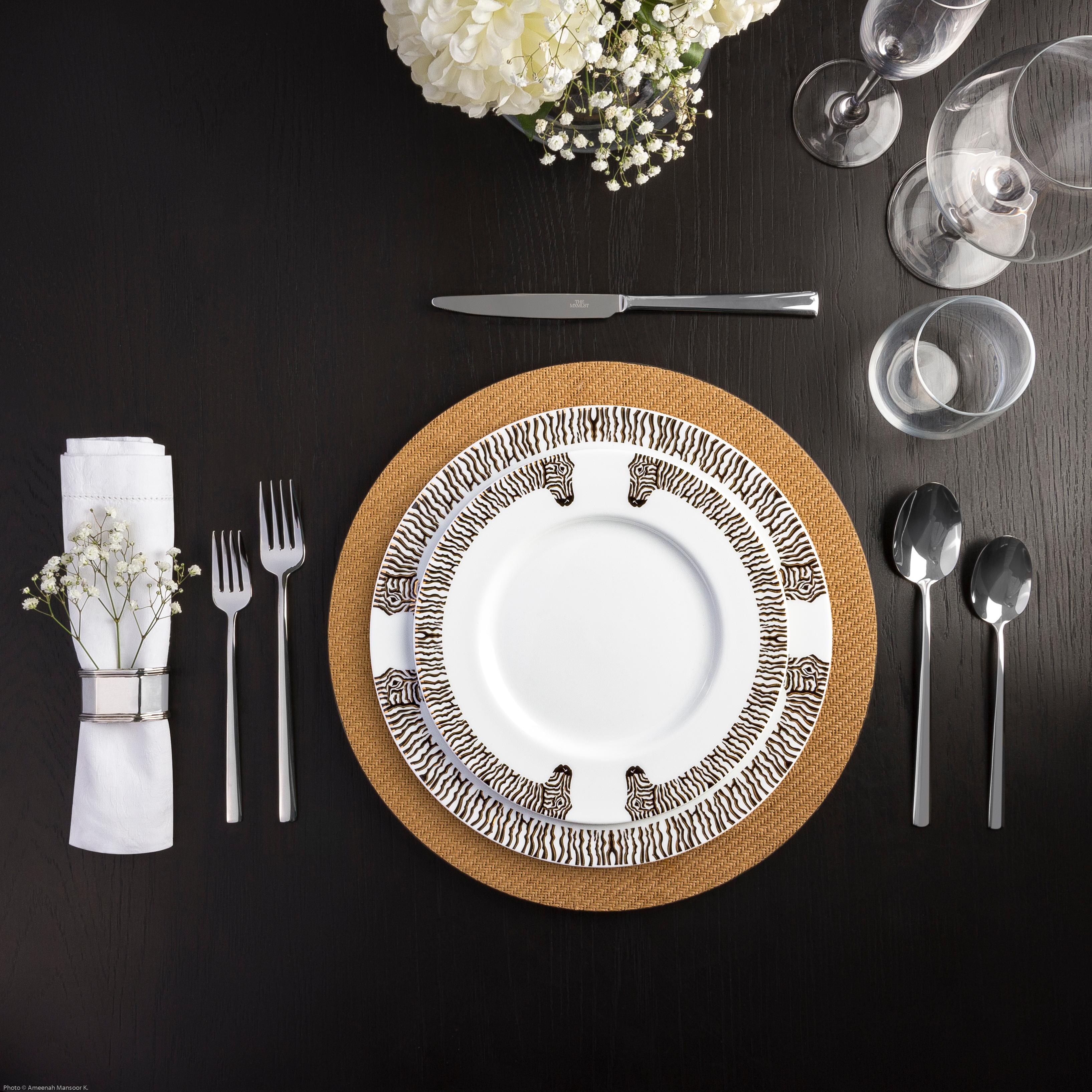 Influenced by the graphic black and white zebra print and the iconic David Webb, the Les Roux dinner set features a zebra that hugs the rim of the plate. Each black stripe is shadowed by a layer of 12k gold to add a touch of luxury to this dinner