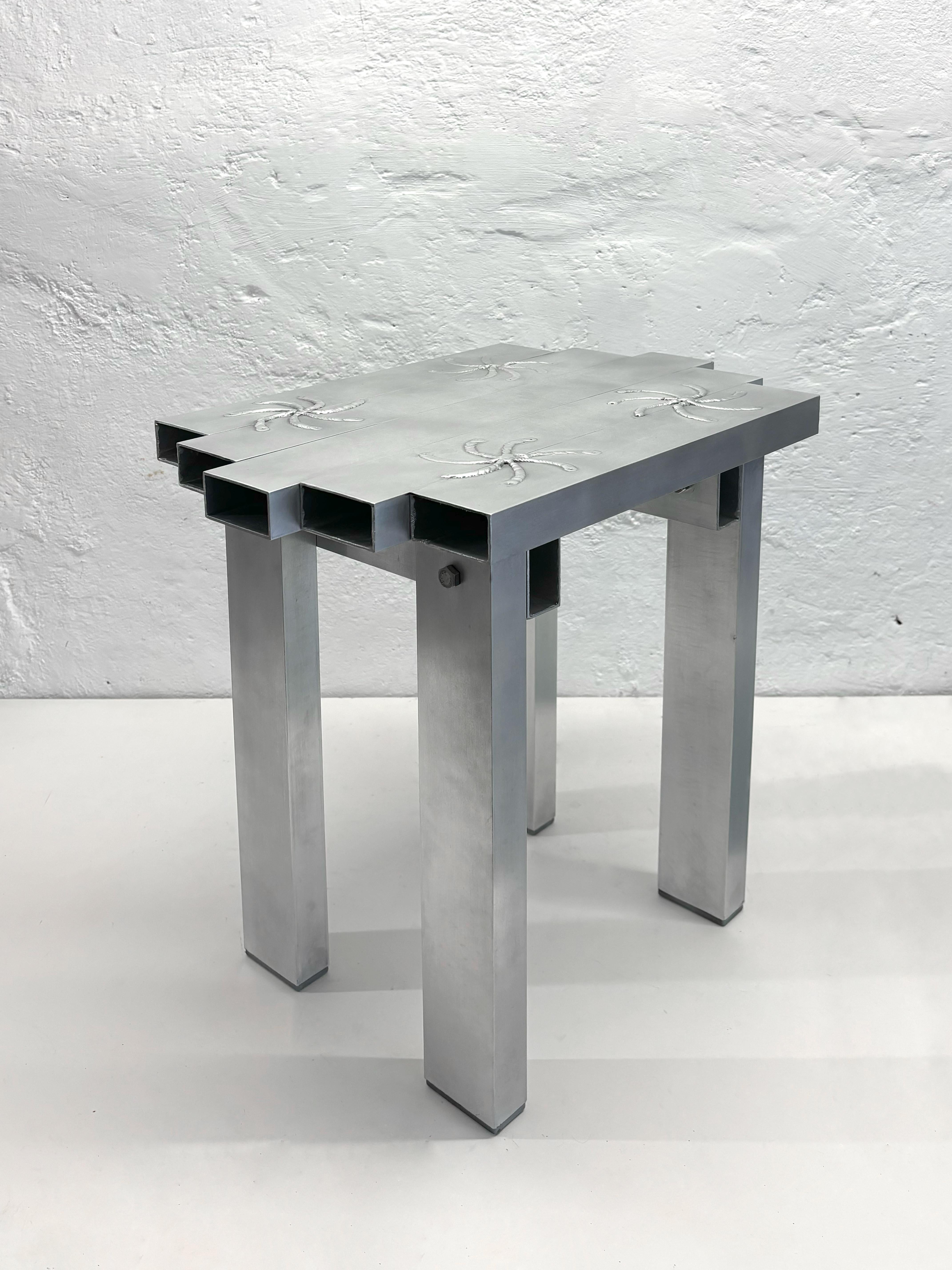 Table Les Savoyards par Mélissa Mariller
Dimensions : D 35 x L 45 x H 40 cm.
Matériaux : Aluminium.

Trois variantes de plateaux de table sont disponibles. Veuillez nous contacter.

Inspiré par le mobilier vernaculaire régional, Les Savoyards est un