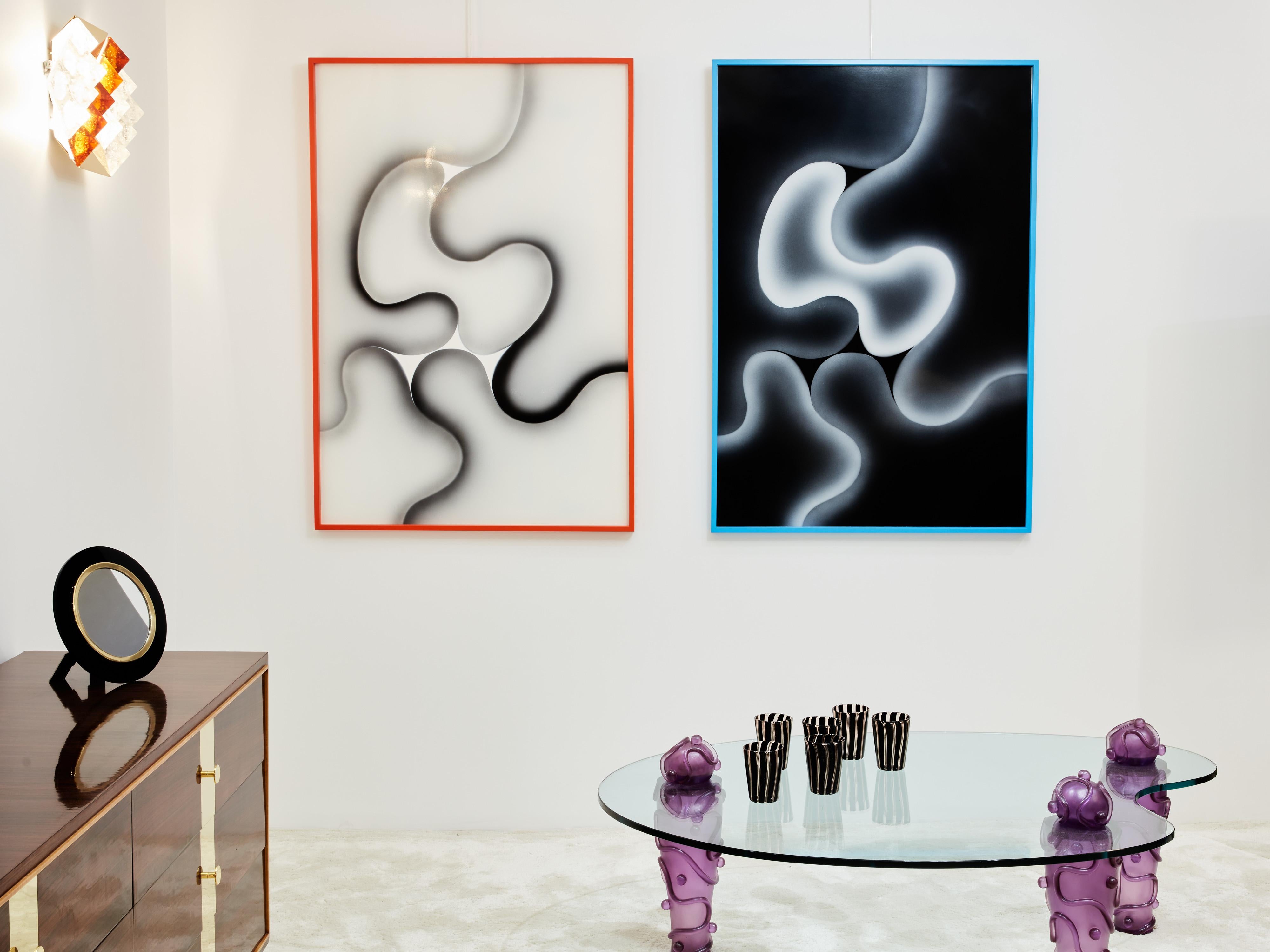 This unique composition, conceived by Les Simonnet, dates back to 1996. Crafted on lucite, the two paintings are nestled within painted wooden shadow boxes. The abstract forms are mirrored from one painting to the other in negative space, while the