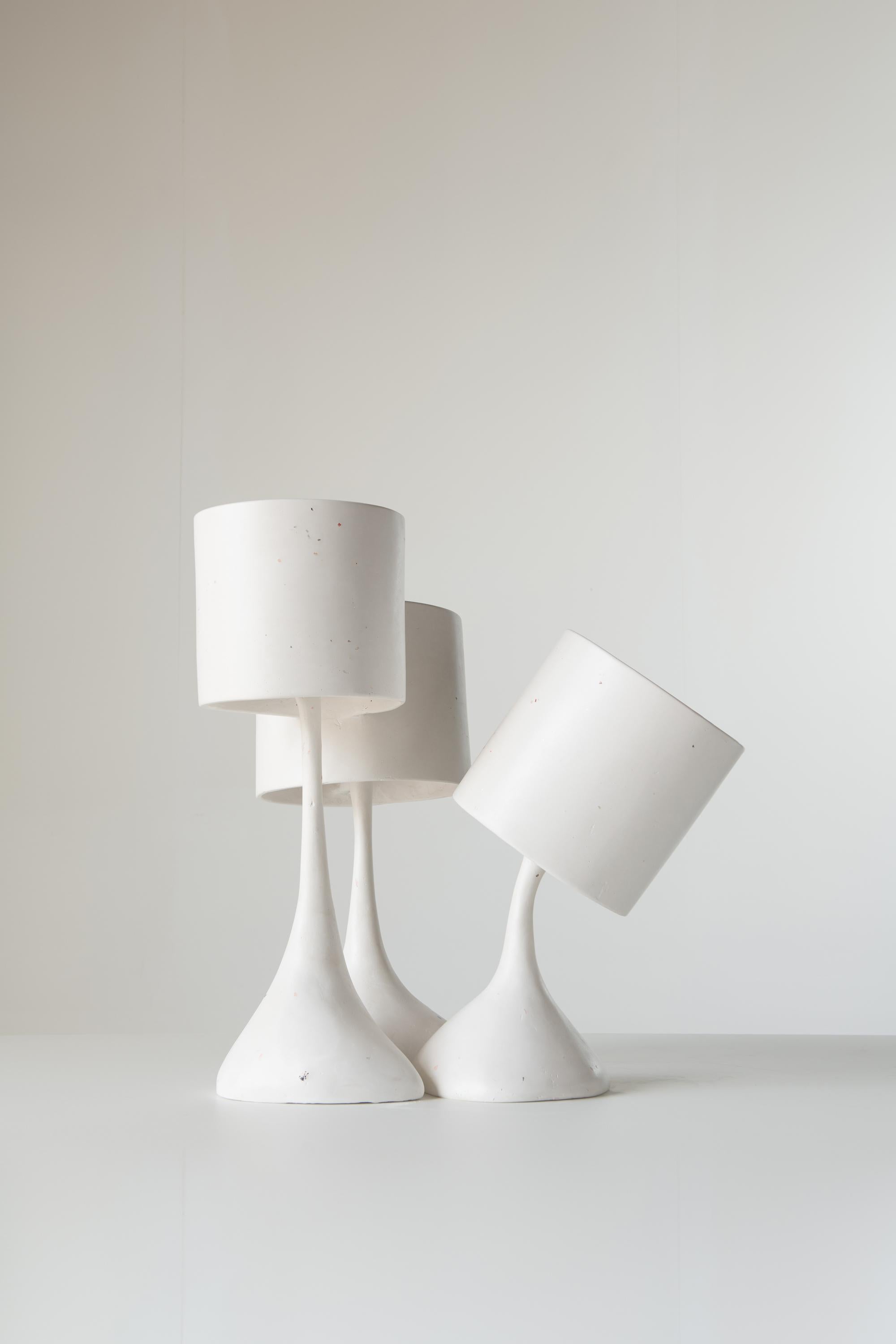 'Les Trois Triste' is an inventive piece comprised of three connected lamps. Hand carved and polished gypsum plaster with seashell inlay.
