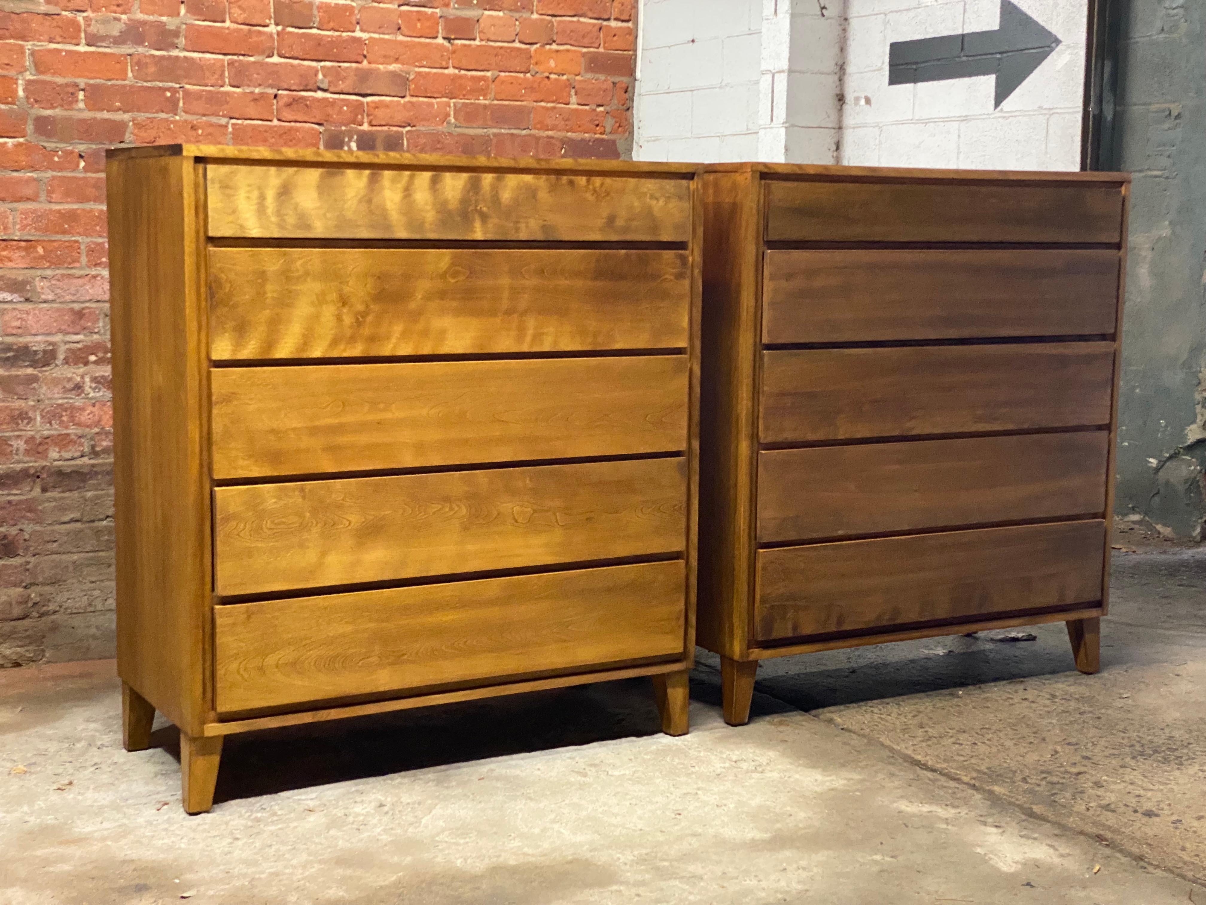 A handsome pair of solid maple five drawer dressers designed by Leslie Diamond for Conant-Ball's American Modern line. Circa 1950-60. The dressers feature tapered block feet, drawer dividers in the second drawer, deep drawers for maximum storage,