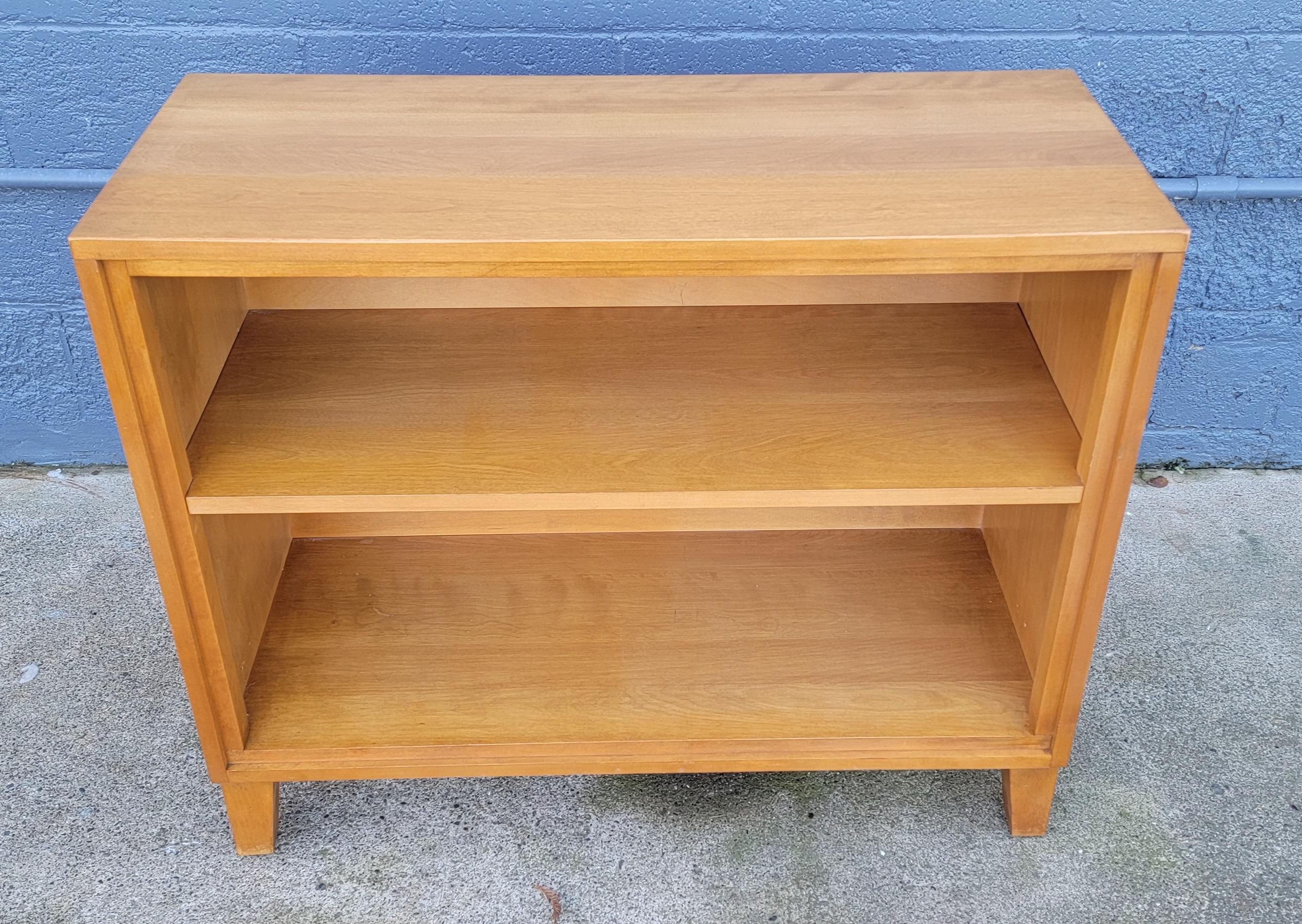 Fine craftsmanship and material in this Solid maple bookshelf designed by Leslie Diamond for Conant Ball. Circa. 1950. Makers mark under middle shelf. Very good original condition, original finish with warm patina. 