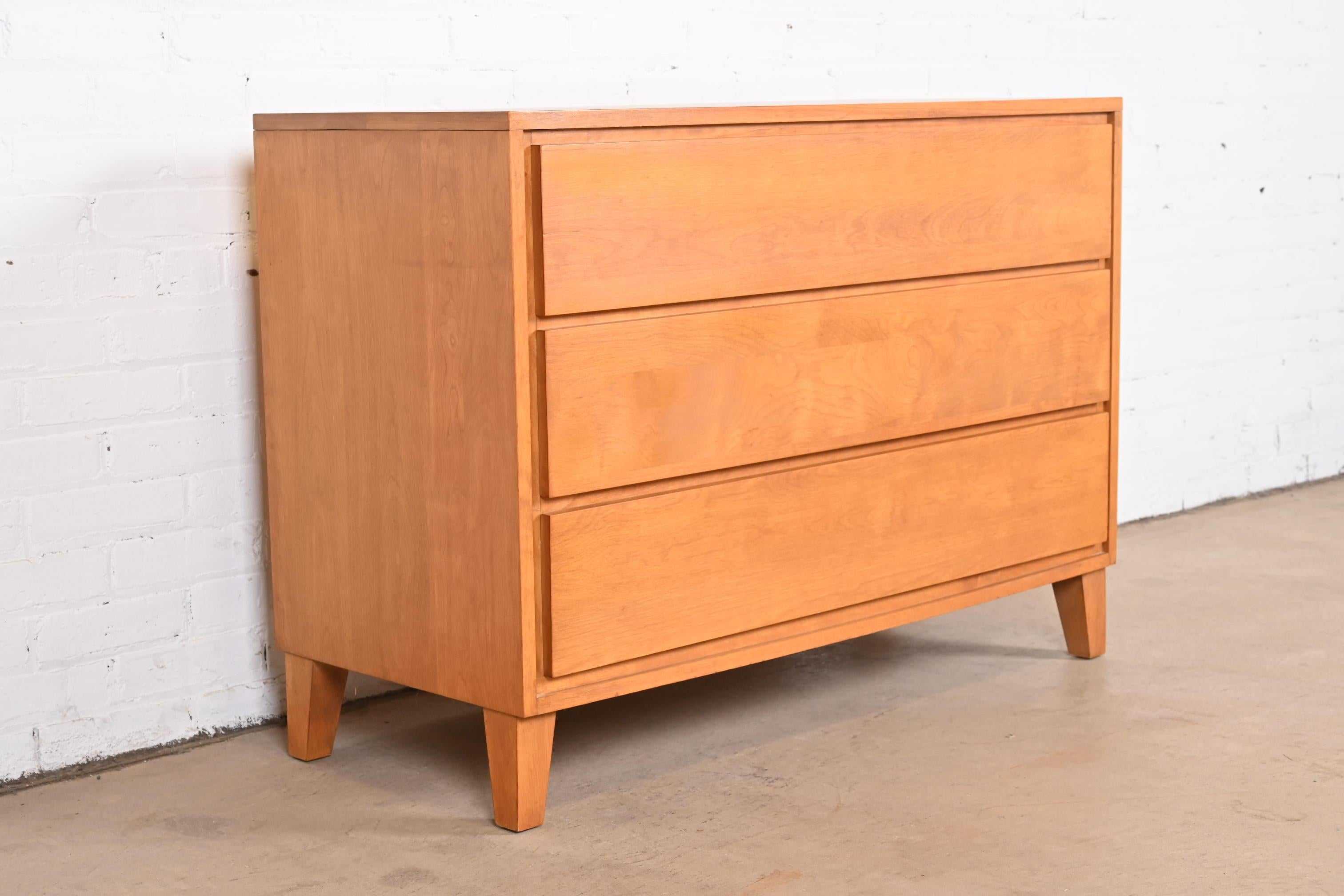 An exceptional Mid-Century Modern three-drawer solid birch dresser or chest of drawers

By Leslie Diamond for Conant Ball, 