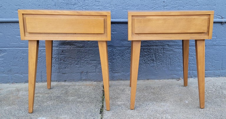 A pair of Mid-Century Modern solid maple nightstands or end tables designed by Leslie Diamond for Conant Ball, circa. 1950's. Each having a single drawer. Sleek, modern design. Excellent original condition with original finish. 
