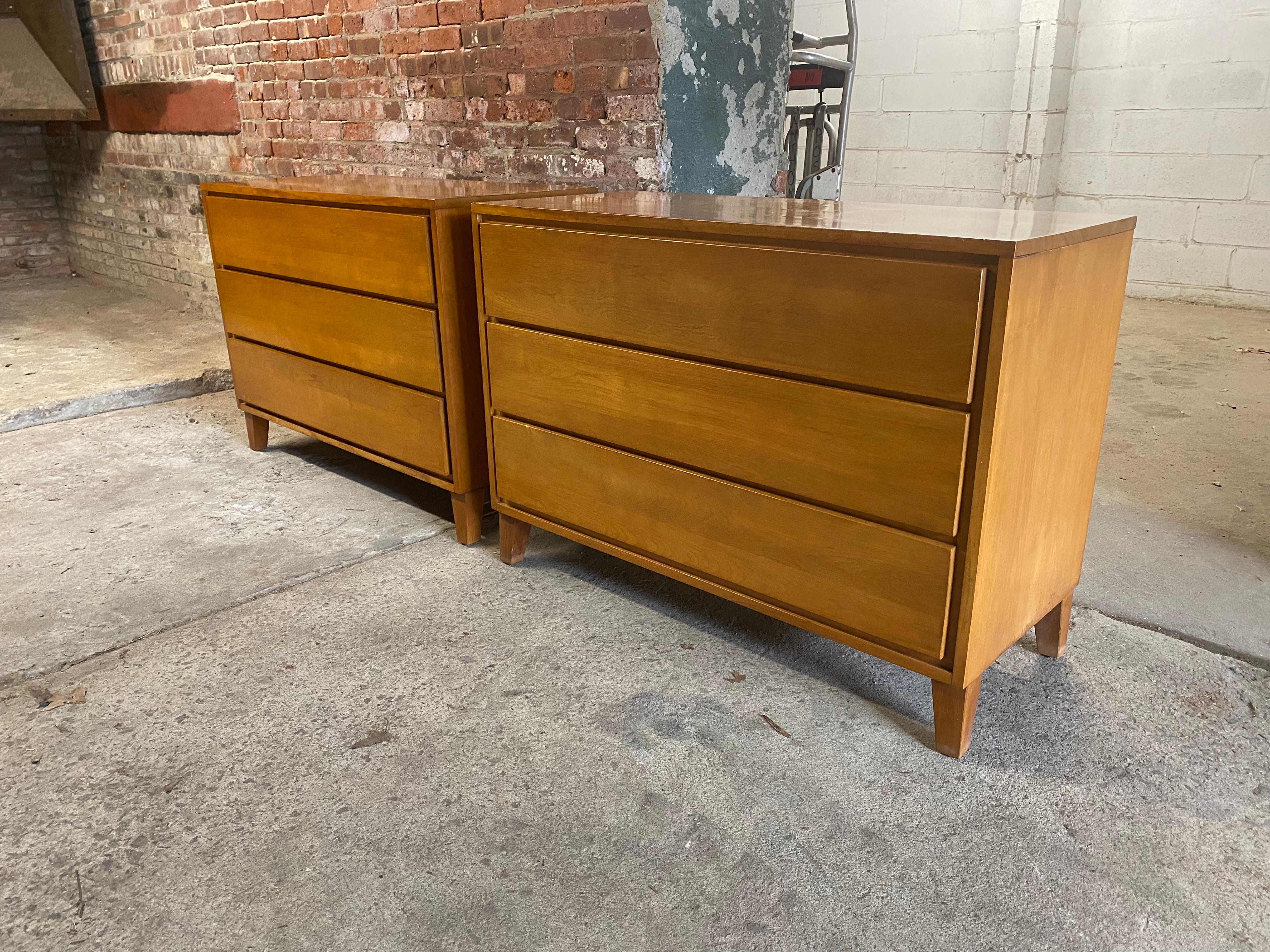 A very clean pair of solid maple three drawer dressers designed by Leslie Diamond for Conant Ball American Modern line. Circa 1950-54. The block front dressers feature solid maple construction, three deep drawers with hidden channel handle and