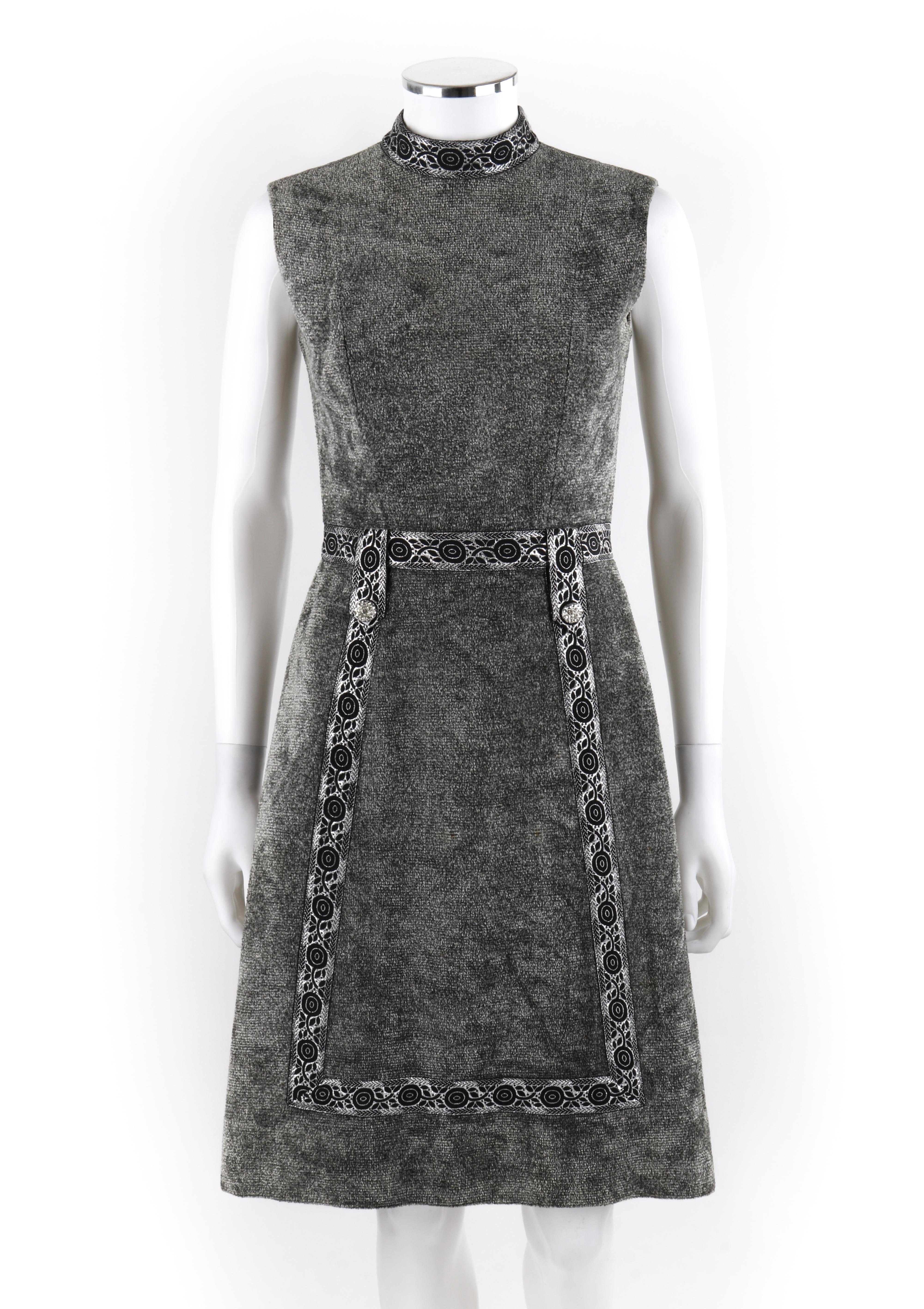 LESLIE FAY Original c.1960’s Gray Silver Mock Neck Sleeveless Mod A-line Dress

Circa: 1960’s
Label(s): Leslie Fay Original; ILGWU tag
Style: A-Line dress
Color(s): Shades of gray, silver, and black
Lined: Partial 
Unmarked Fabric Content (feel of):