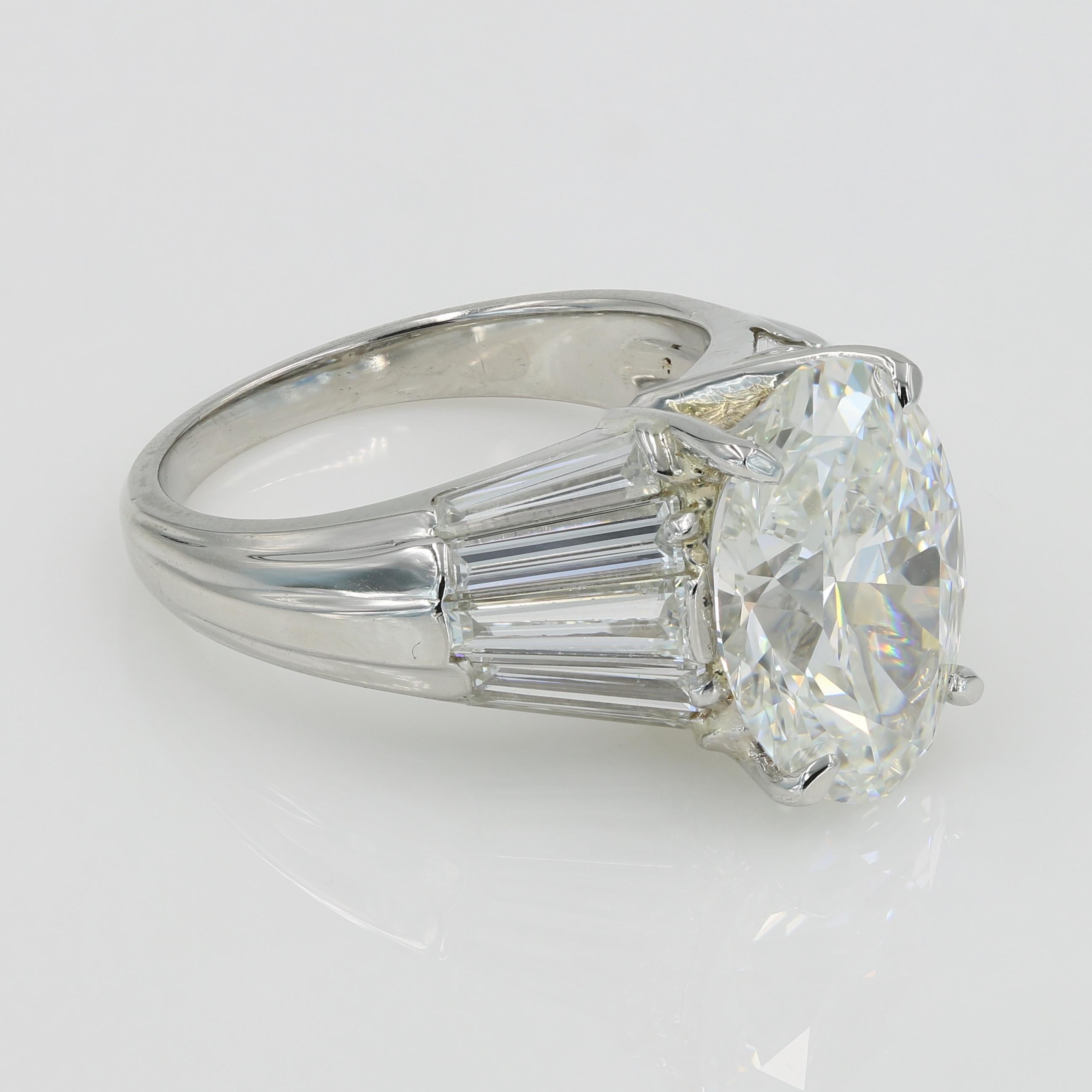 Lester Lampert Signature ring with a beautiful 5.05cts Oval cut diamond, G-VS1 with GIA grading report (#2195525032) set in our platinum with 10 Tapered Baguette cut diamonds =2.40cts. 