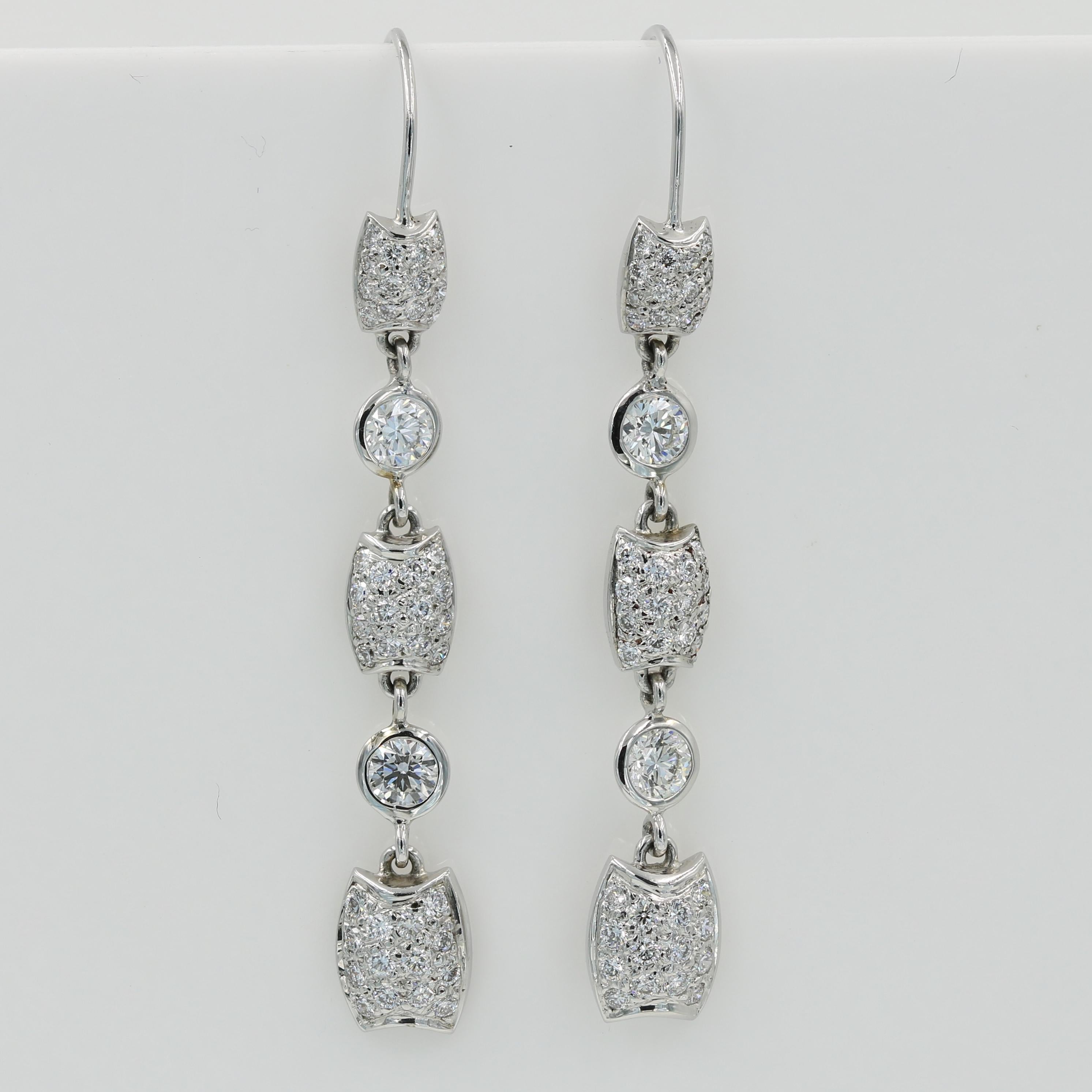 Lester Lampert Diamond Dangle Earring on a Wire back - 

18kt. white gold dangling pavé diamond earrings, each featuring three pavé sections and two 