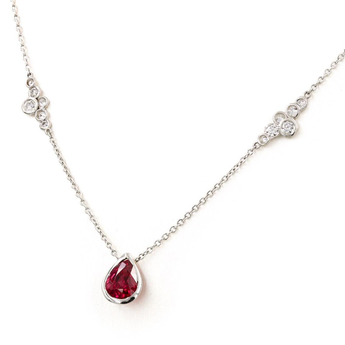 This Lester Lampert original necklace in platinum has a pear shape ruby center = .98ct. and two small pirouette diamond sections with .40ct. t.w. (the diamonds are G-H in color and VS clarity) The ruby stone is from Thailand and has only been heat