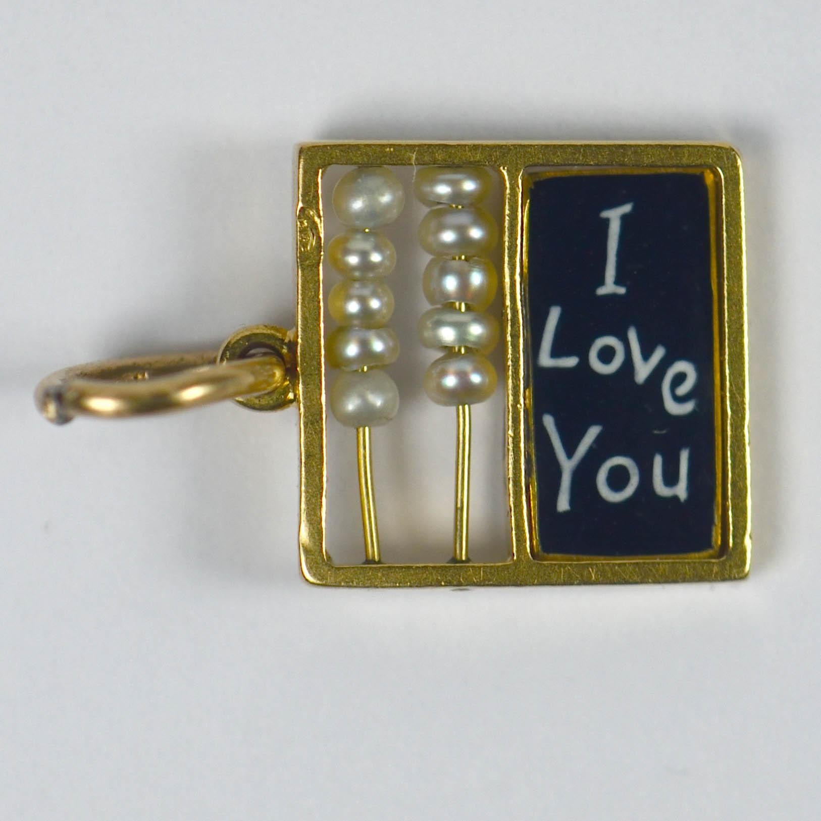 An unusual charm designed as an abacus set with two lines of natural seed pearls next to an enamelled 'blackboard' inscribed 'I love you'. Marked 18ct for 18 karat gold with the owl poincon for French import. 1/2